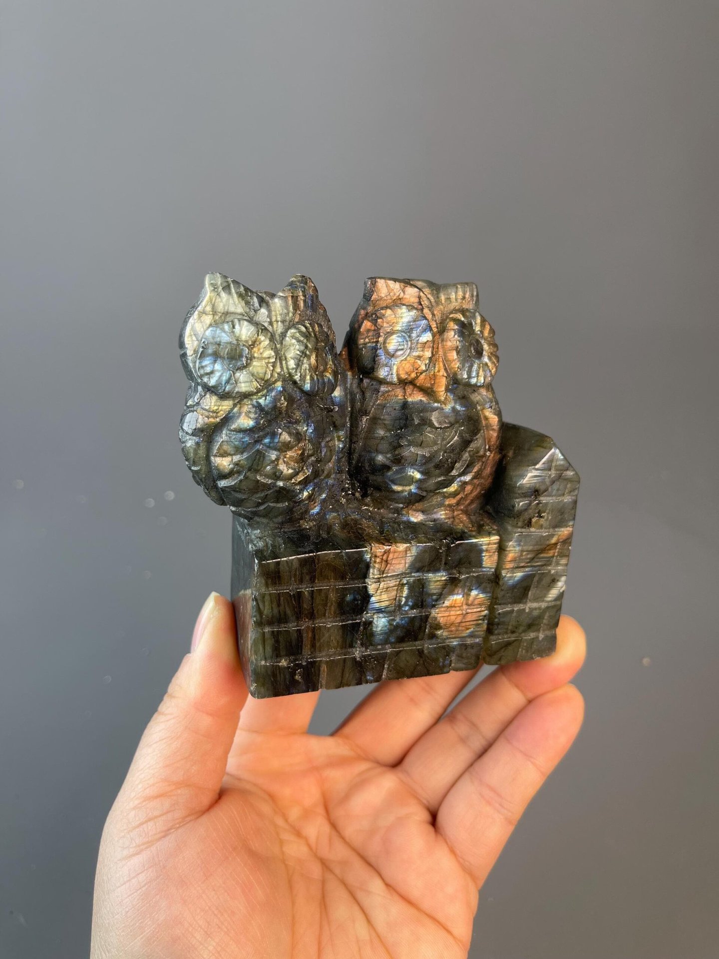 Front view of labradorite owl displaying iridescent blue-green play of colour