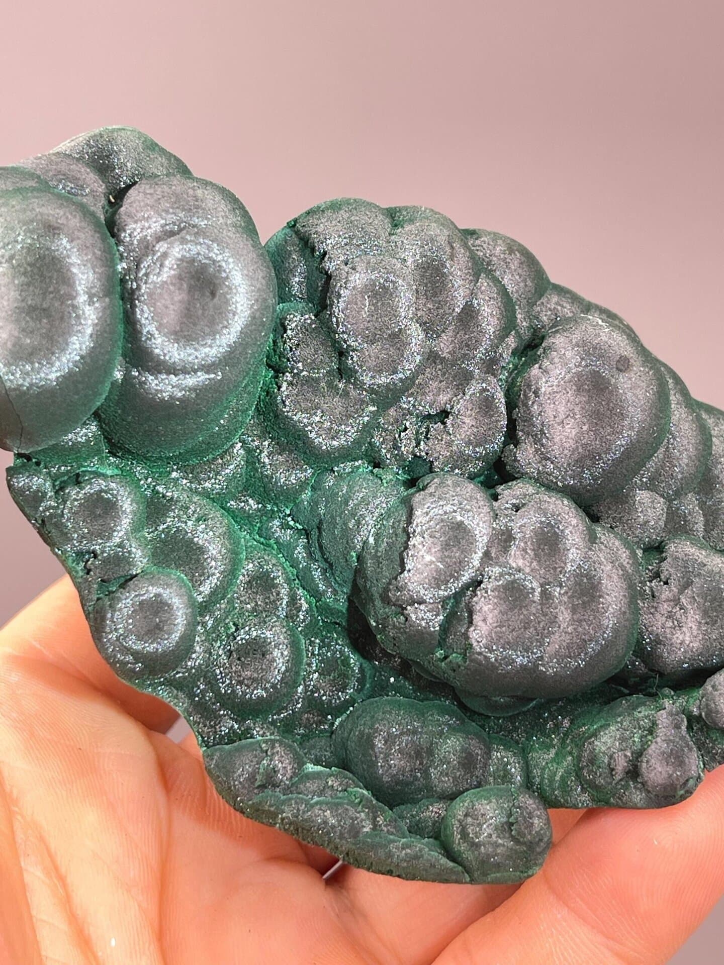 Close-up of silky banded malachite nodule surface
