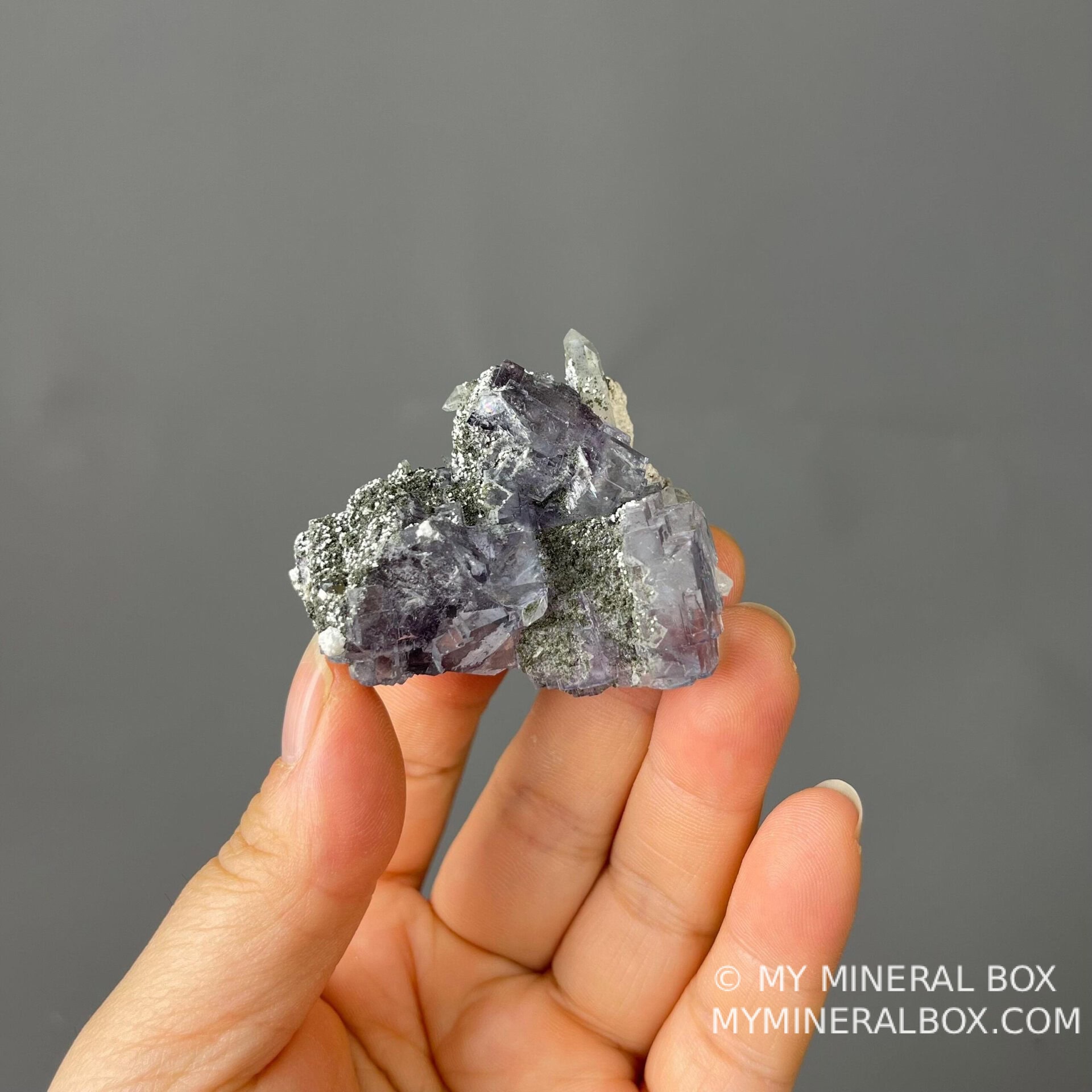 Purple fluorite quartz twin displaying vitreous luster