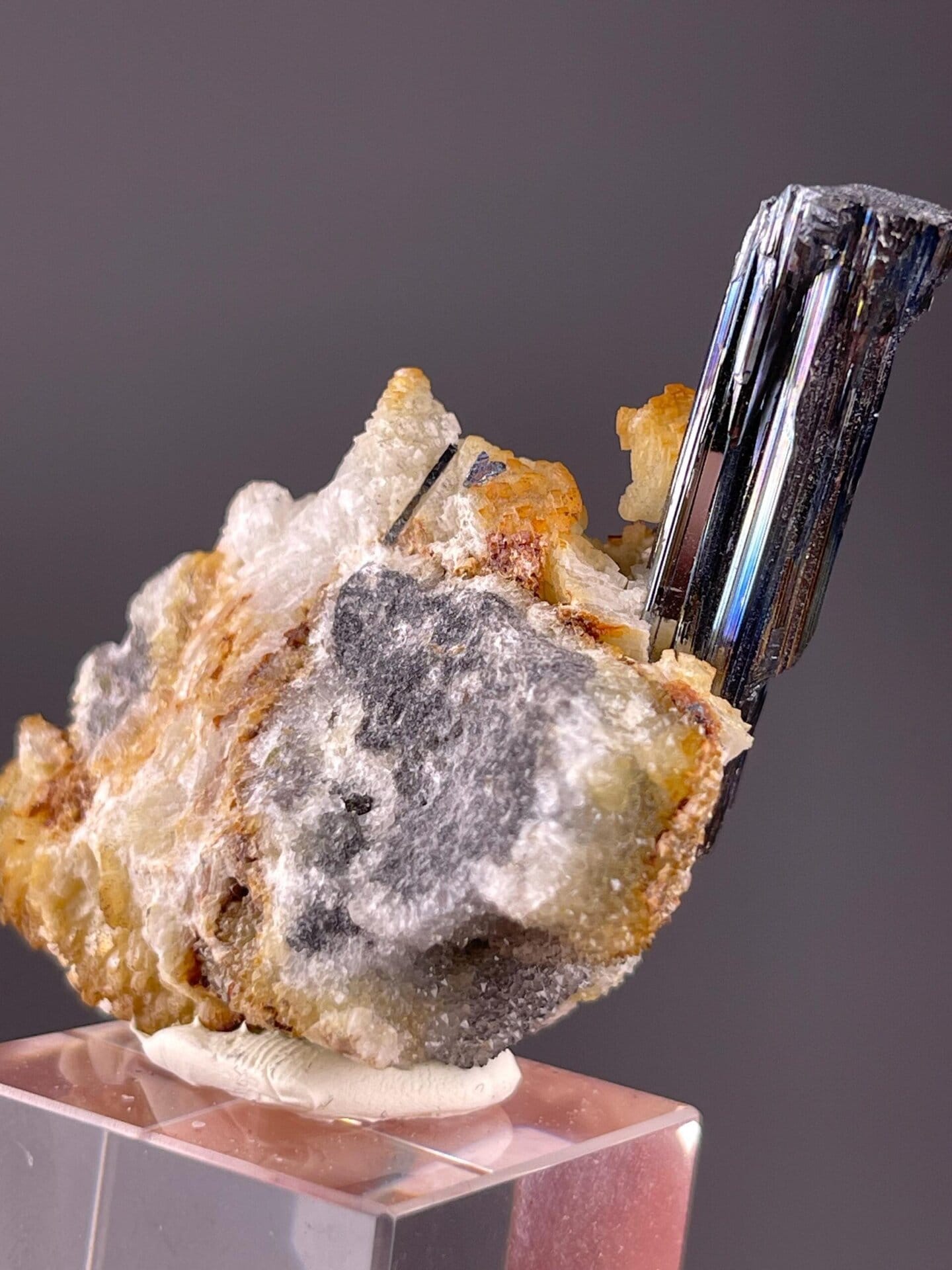 Stibnite crystal on matrix displaying metallic luster