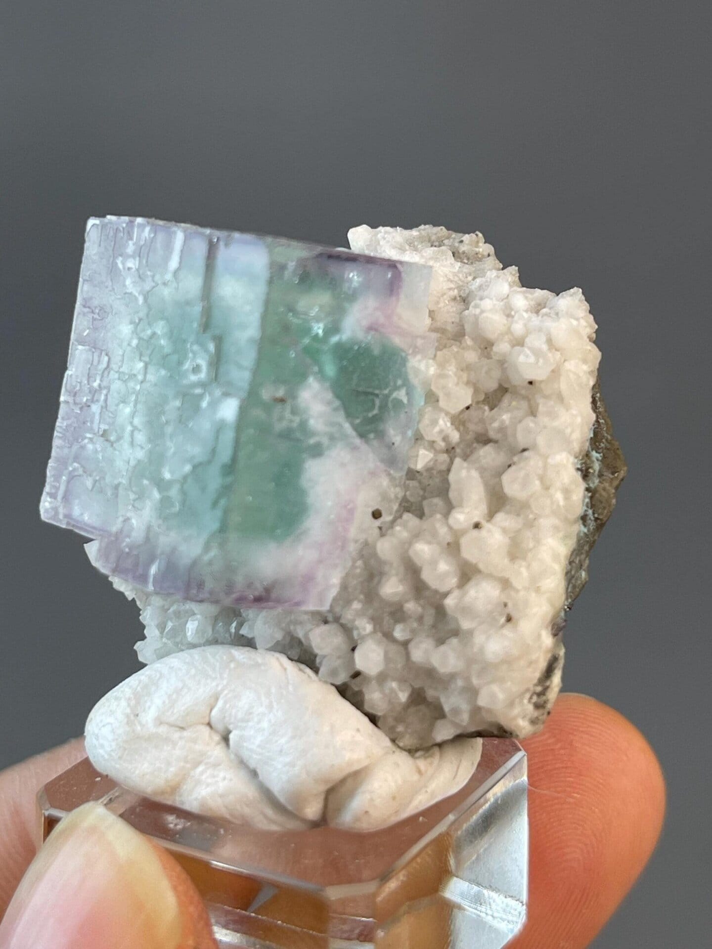 Purple fluorite cube displaying vitreous luster on matrix