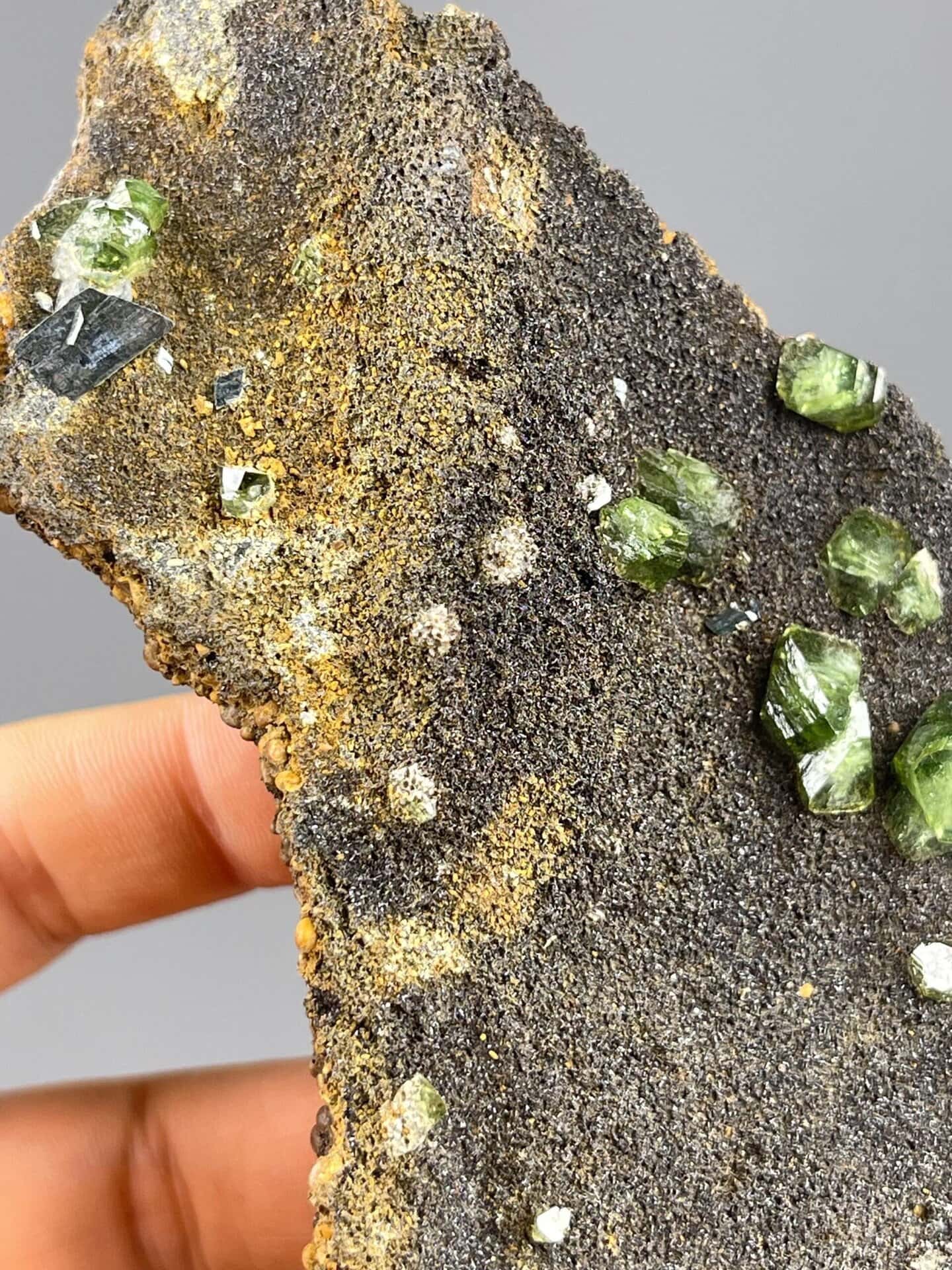 Top view of green andradite garnet on dark matrix, Guangxi