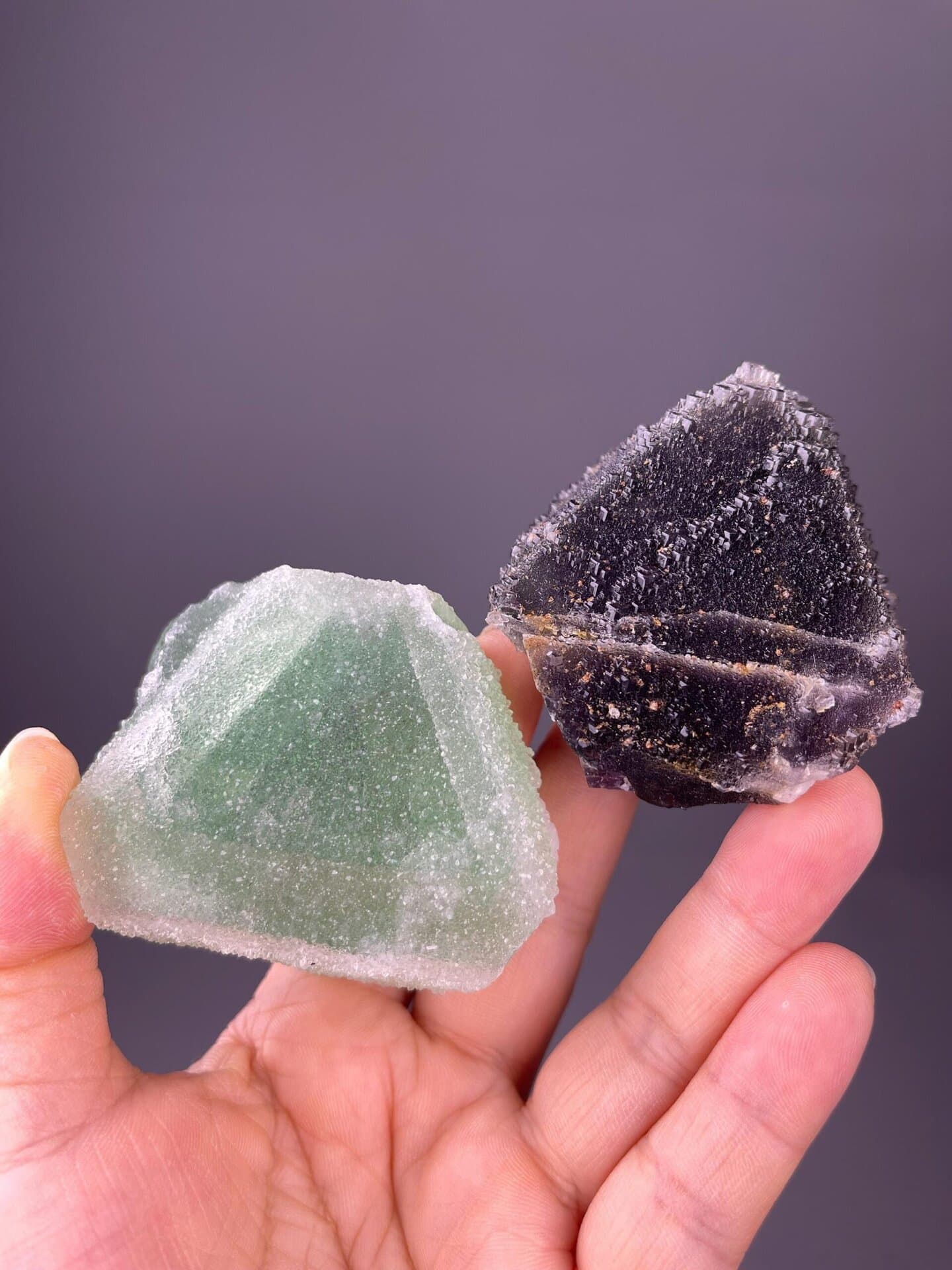 Mint-green and deep violet fluorite pair with druze texture