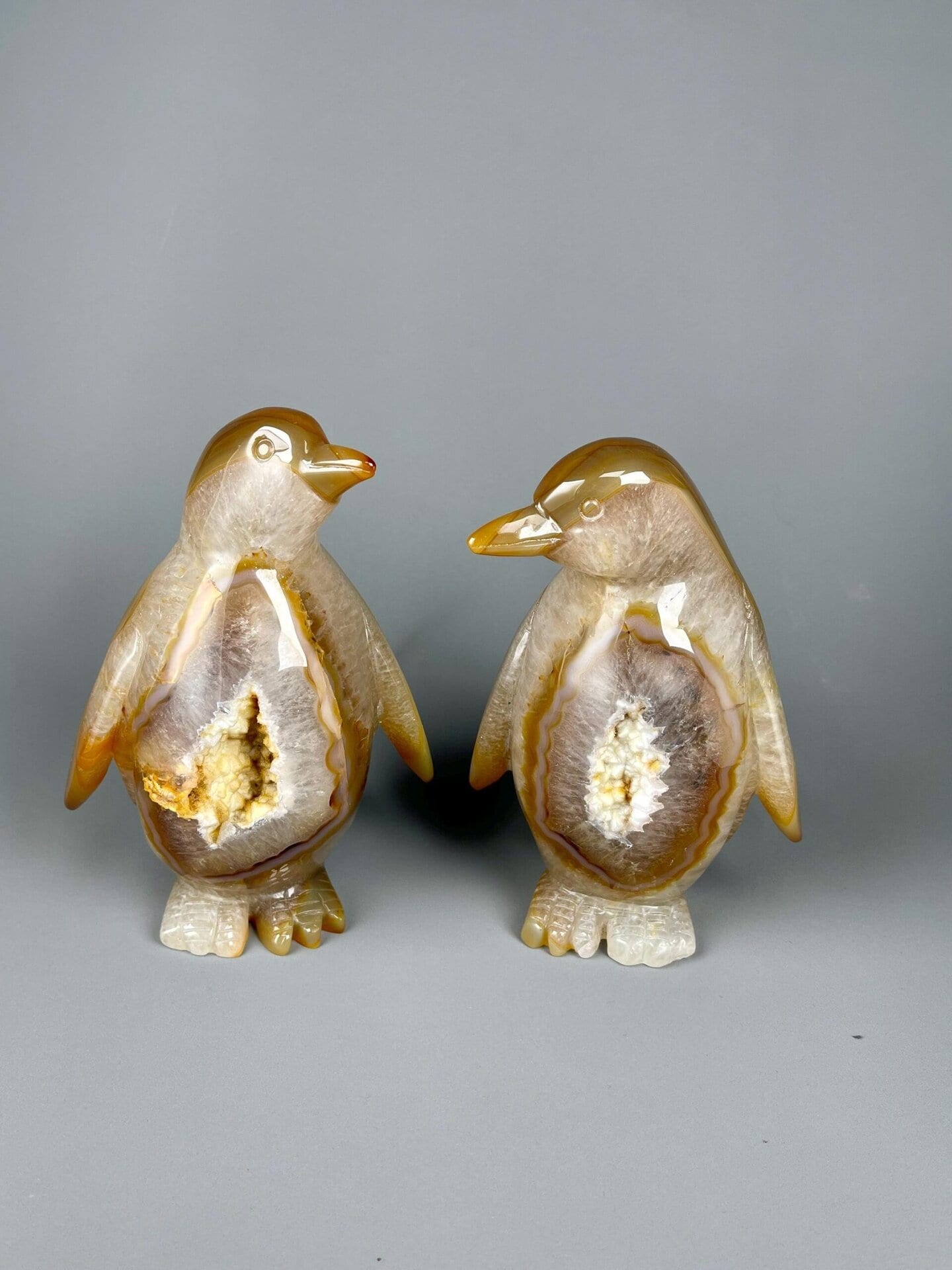 Two agate penguins carved from Brazilian banded agate