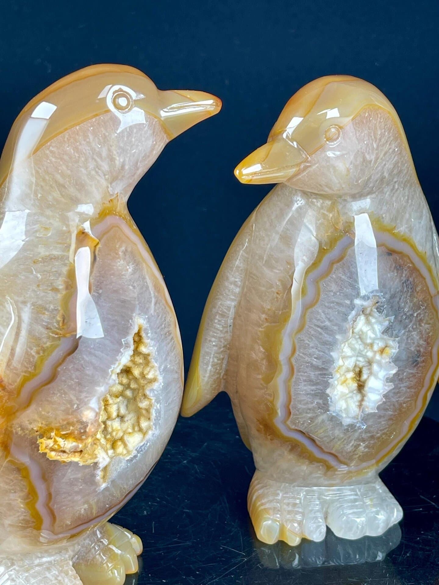 Side view of hand-carved agate penguin pair, Brazil
