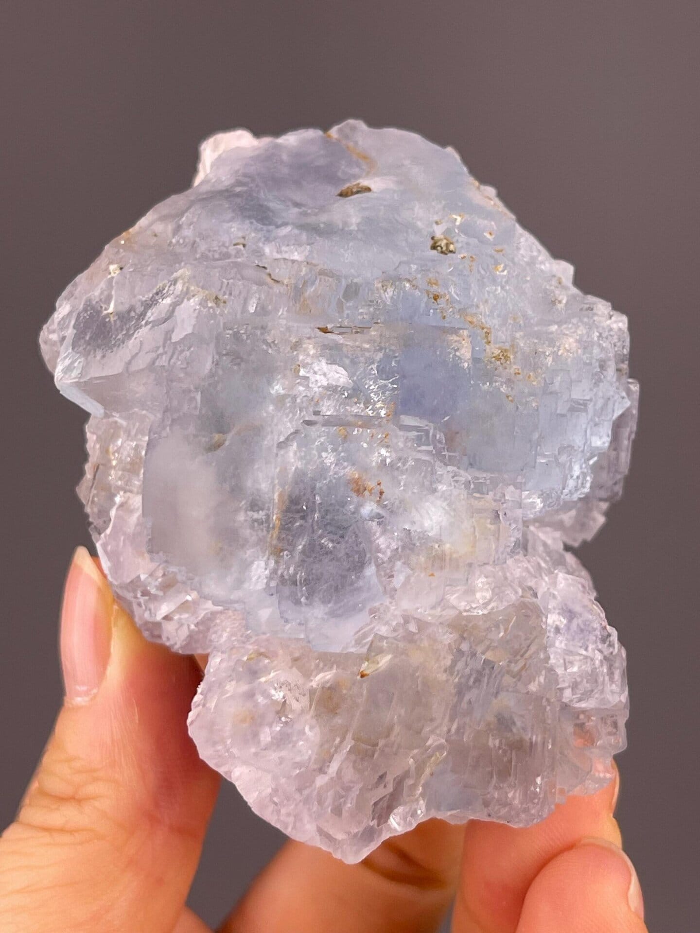 Icy blue fluorite with translucent cubic crystal habit