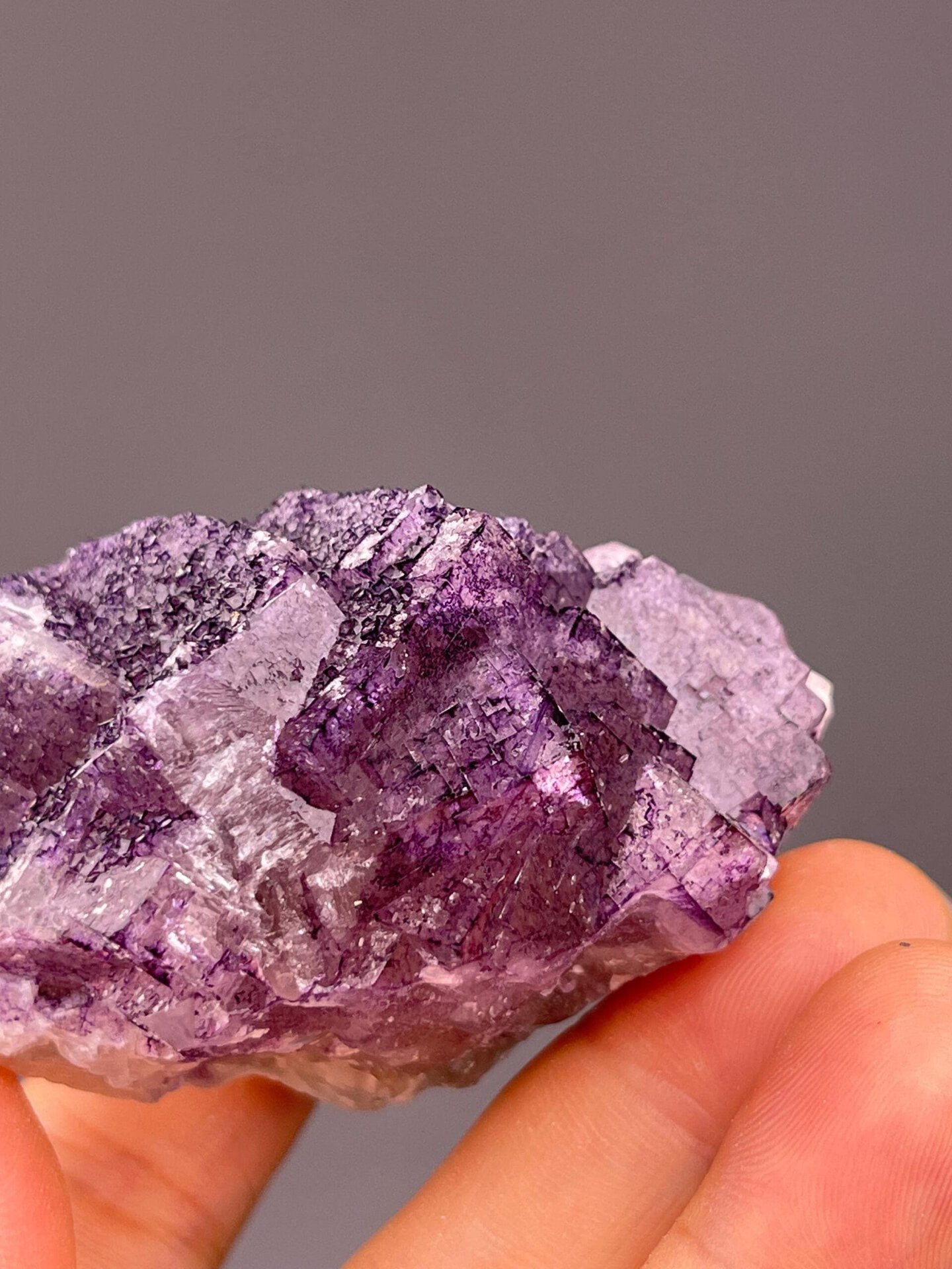 Textured purple fluorite specimen with dimensional crystal surface