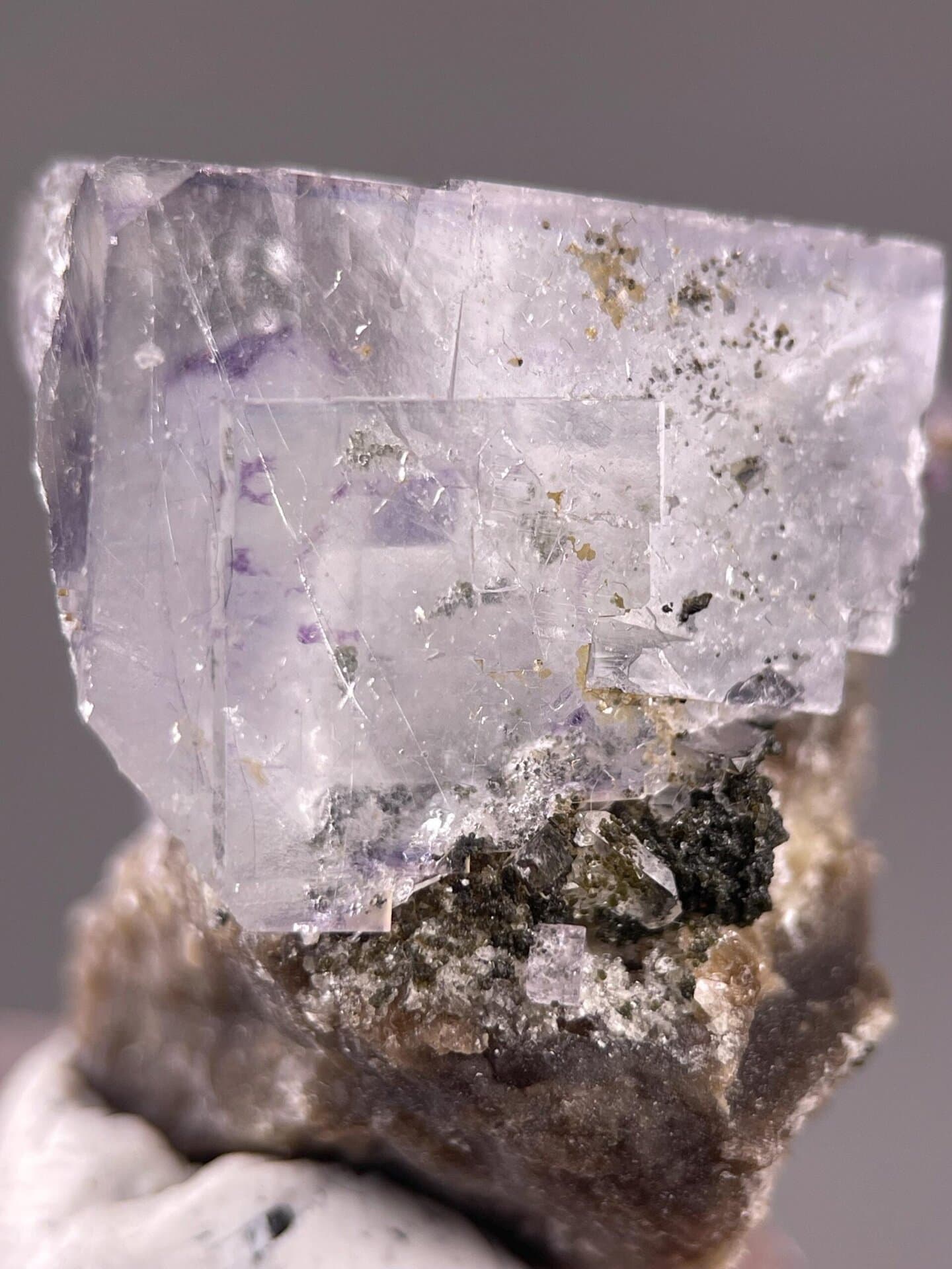 Cassiterite matrix beneath phantom fluorite crystal