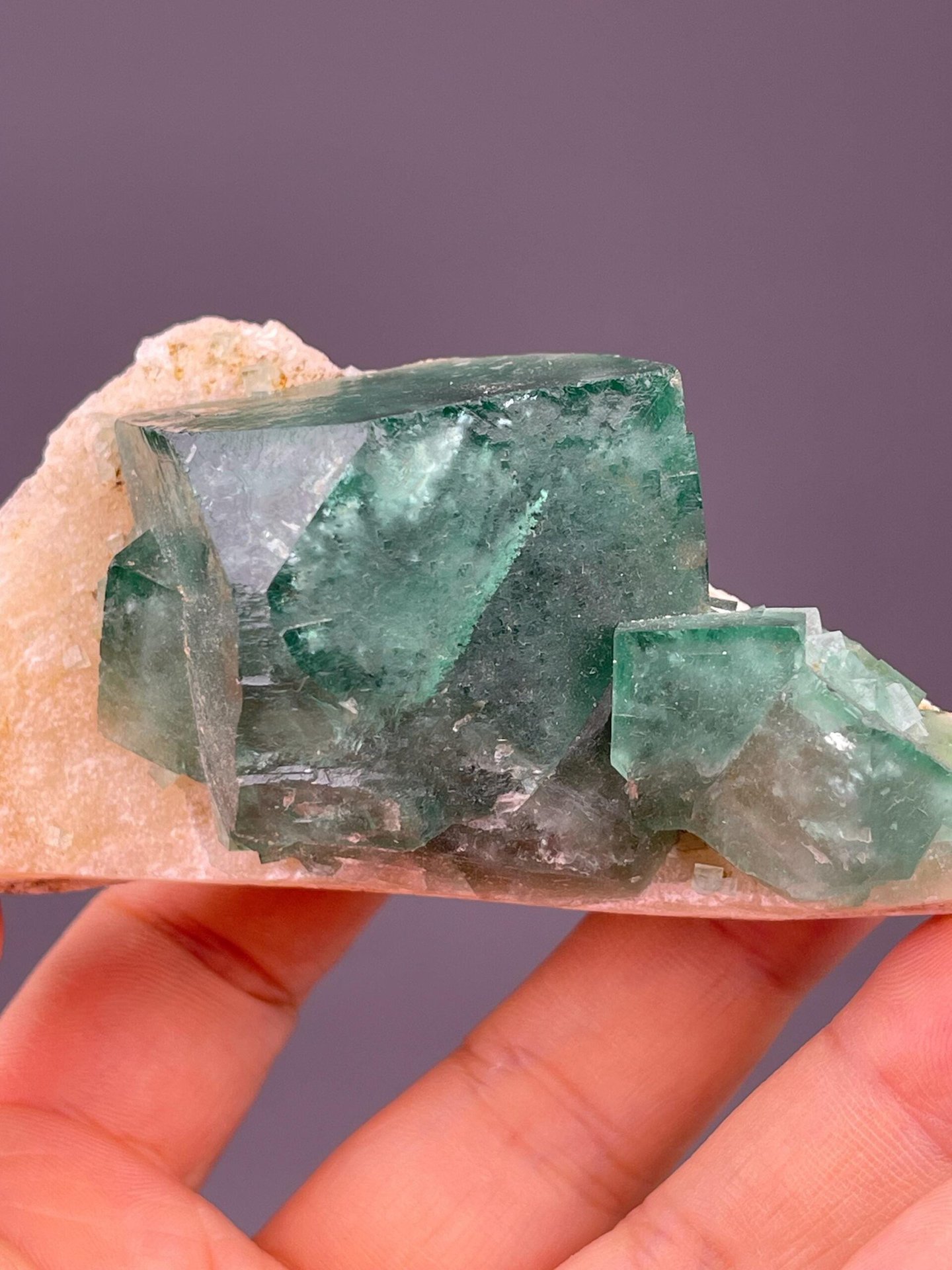Angled view of daylight-reactive green fluorite cube