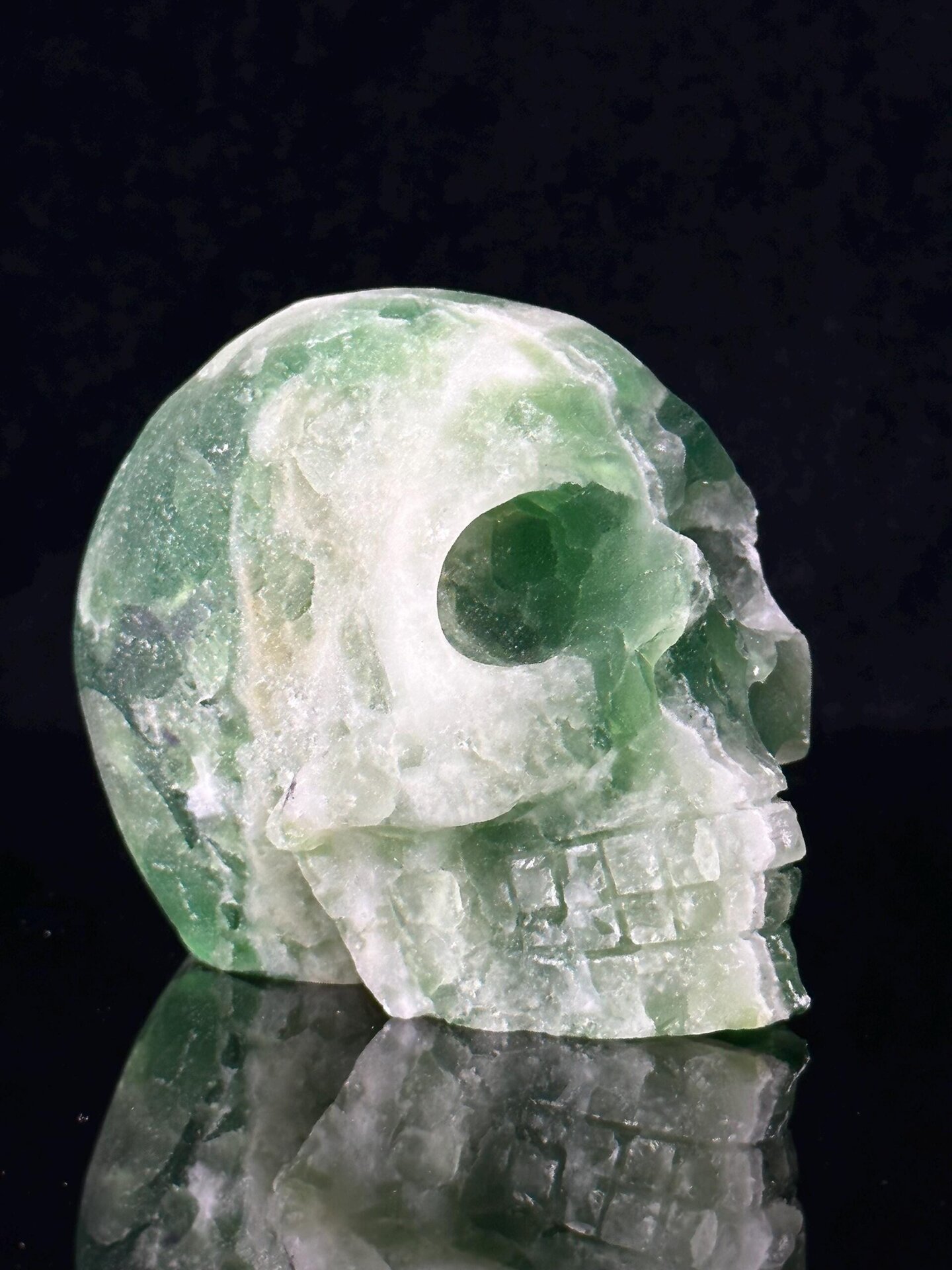 Hand-carved fluorite skull with natural geode cavity