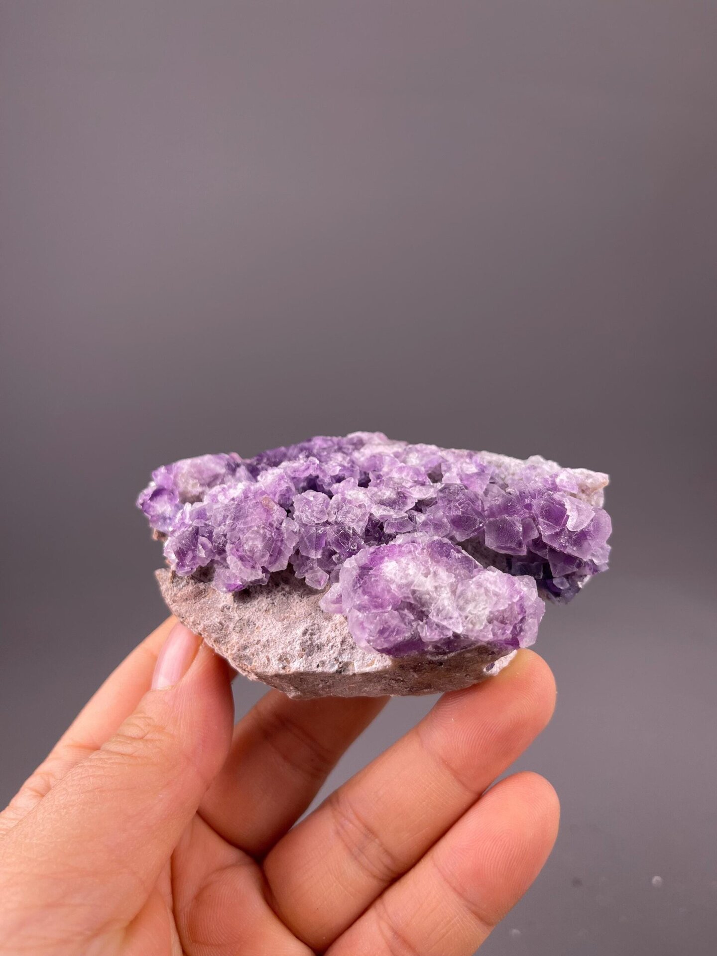 Dense cubic purple fluorite crystal faces close-up