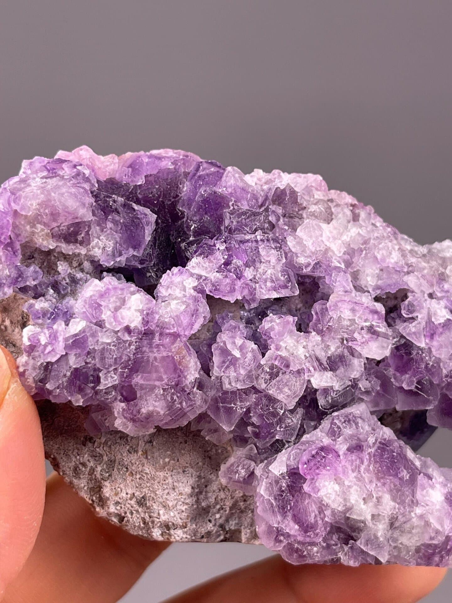 Full purple fluorite cubic specimen on white background