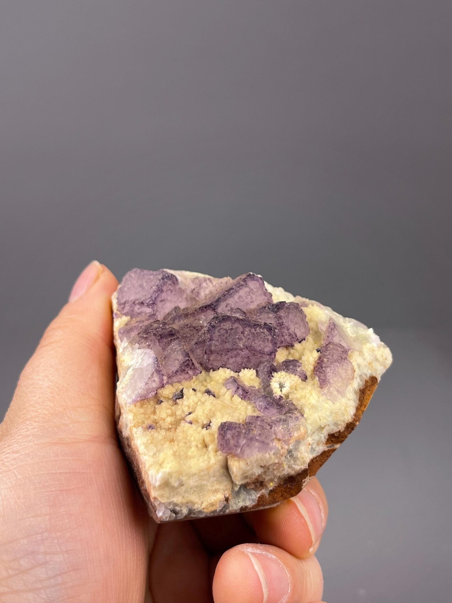 Translucent purple fluorite crystal surfaces lit