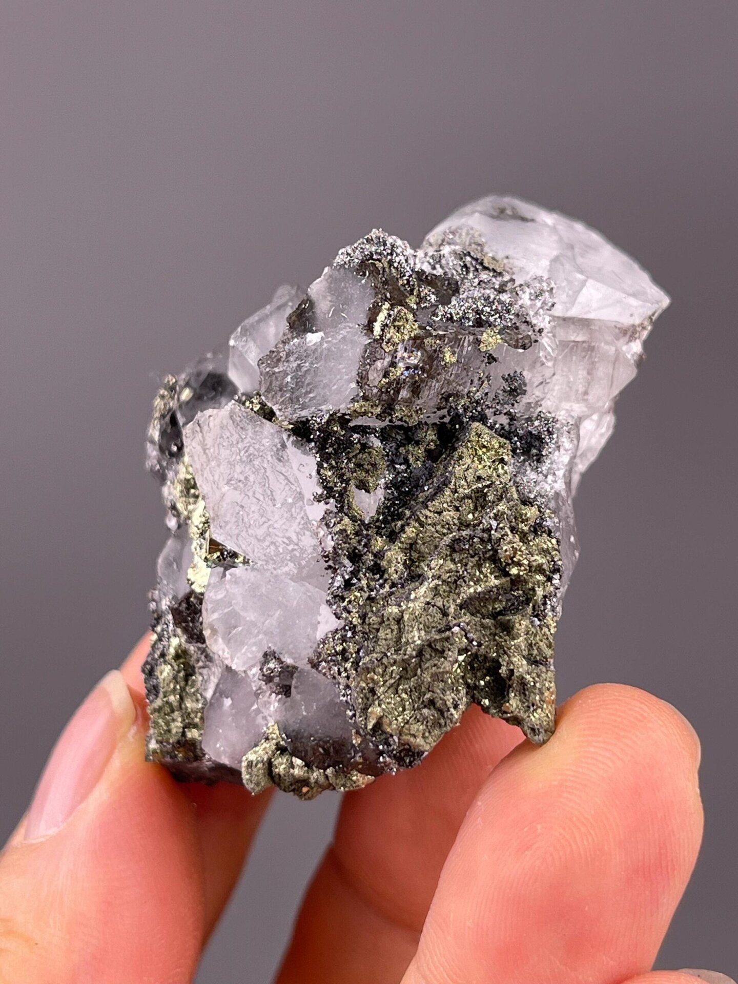 Sharp metallic pyrite cubes on fluorite matrix