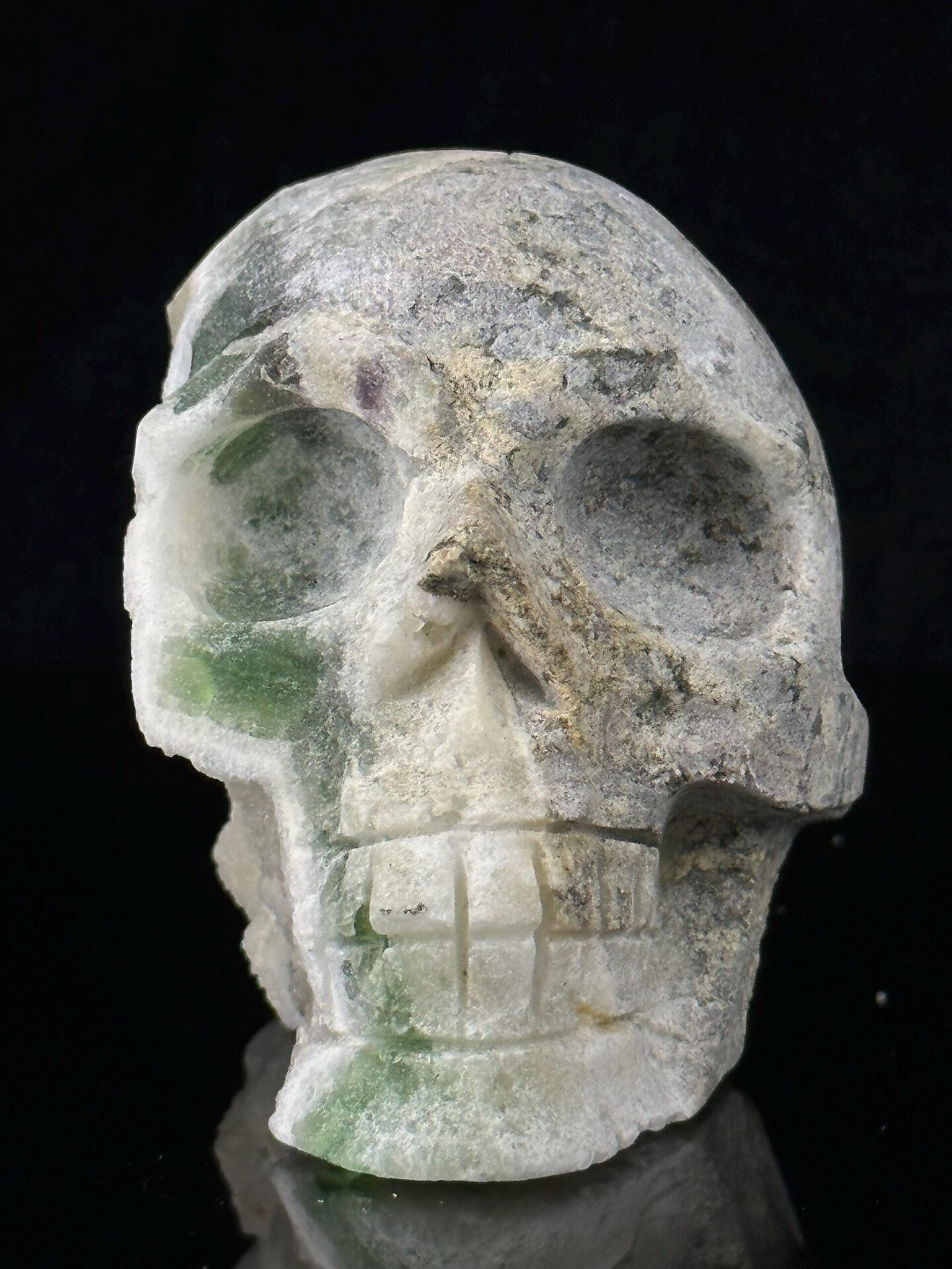 Raw mineral matrix on reverse of green fluorite skull