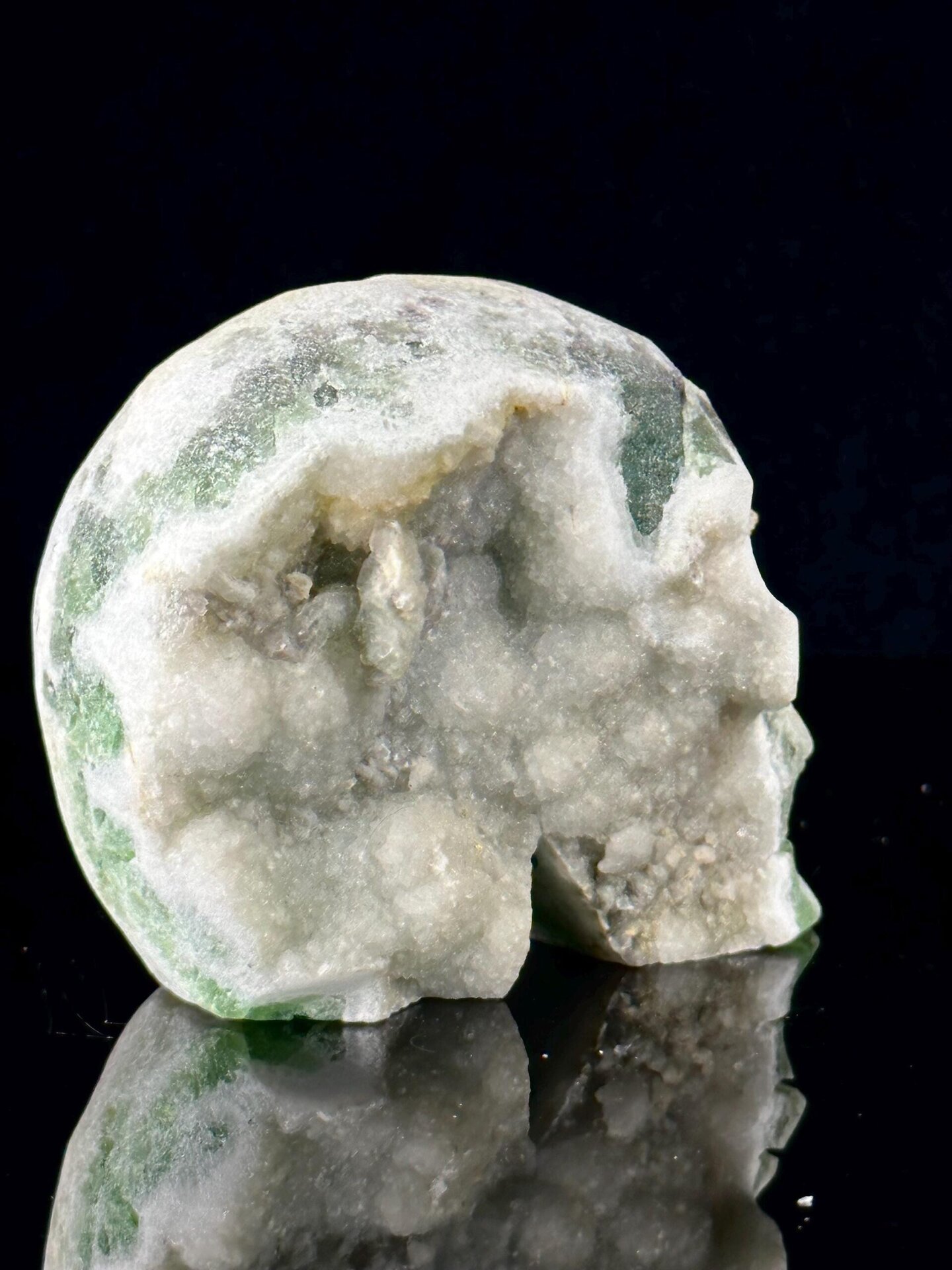 Three-quarter angle of green fluorite skull with matrix
