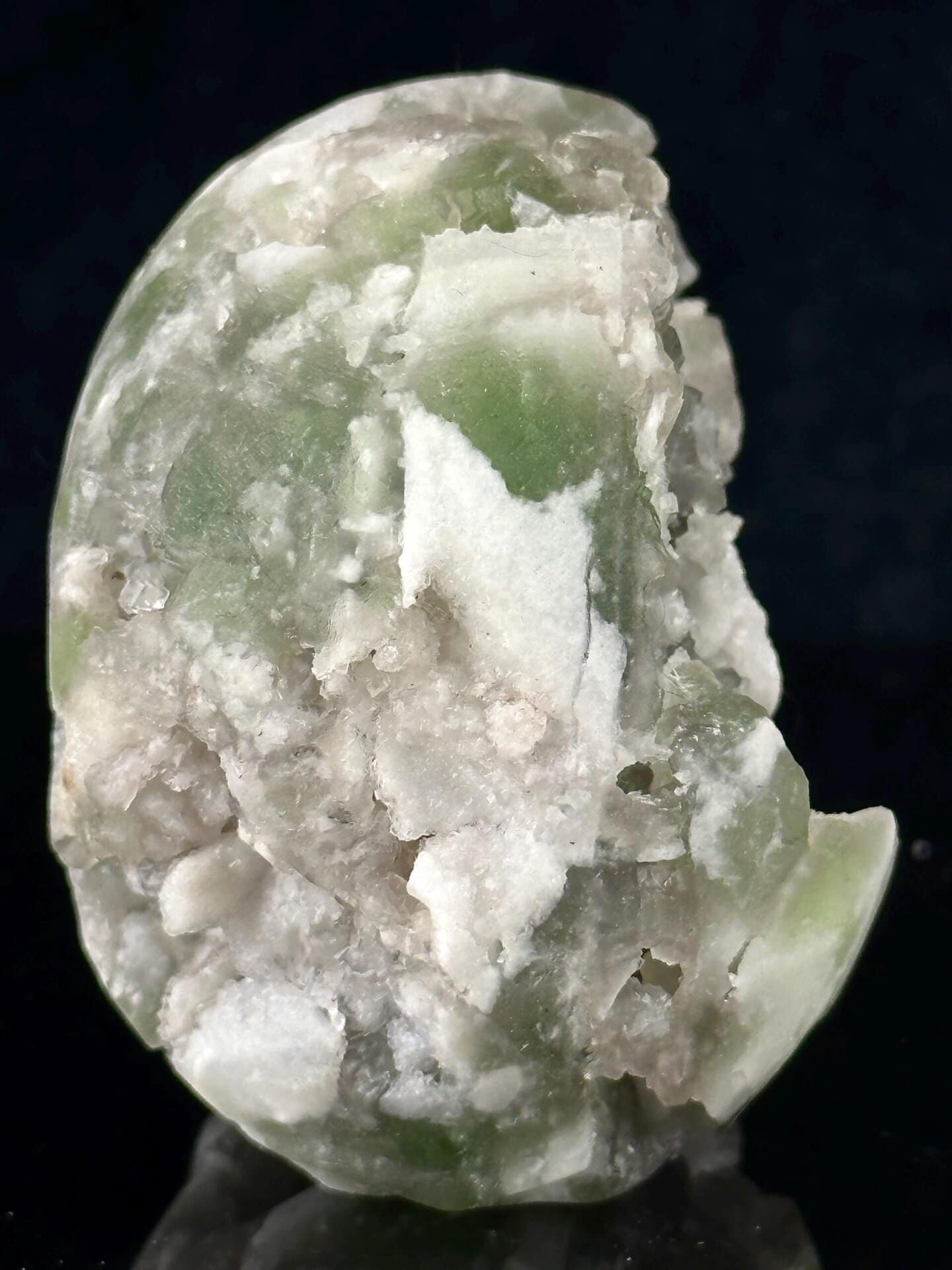 Green fluorite skull under studio lighting