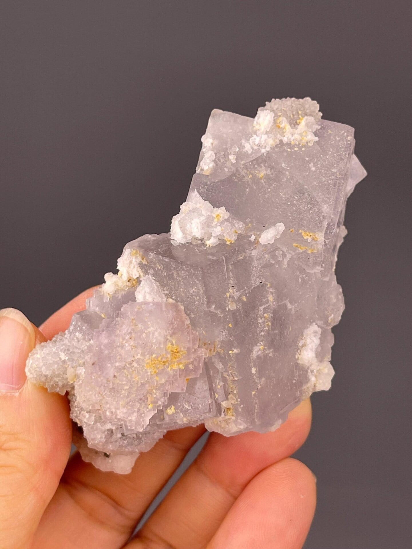 Pale green fluorite visible beneath quartz overgrowth