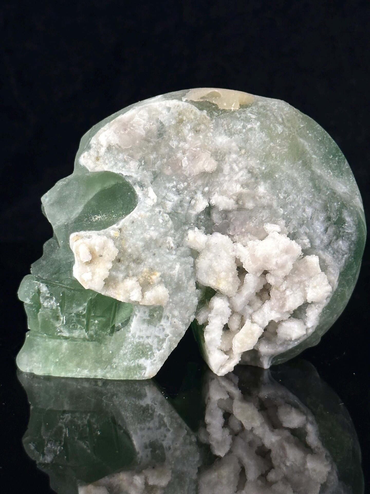 Side profile of green fluorite skull showing geode opening