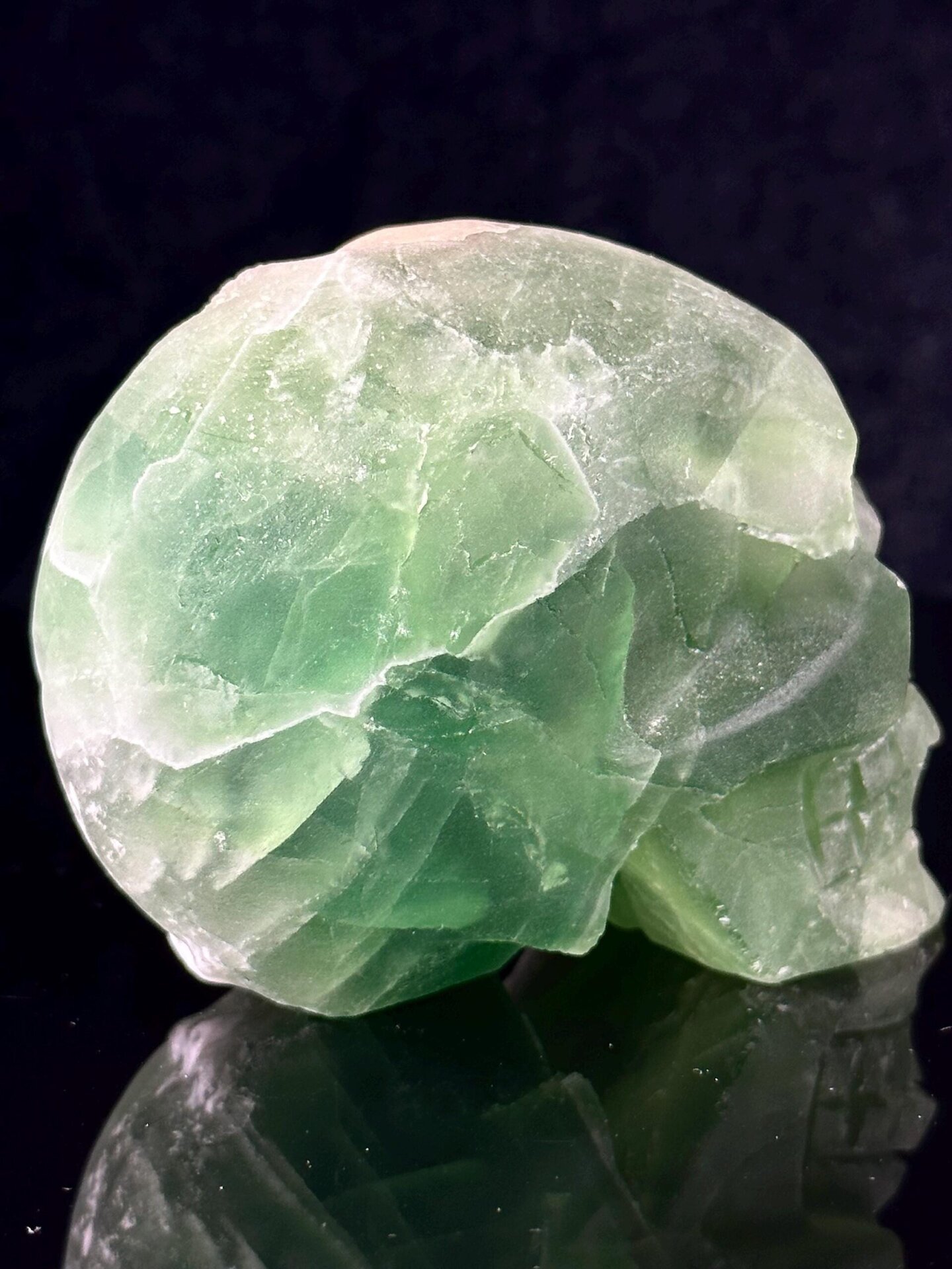 Back view of fluorite skull showing raw quartz geode