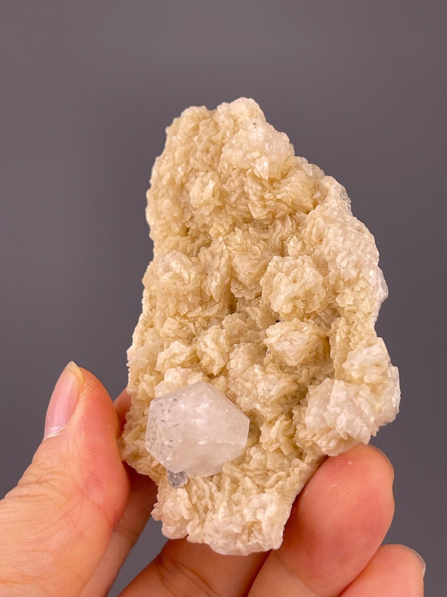 Angled view of clear fluorite crystal on dolomite