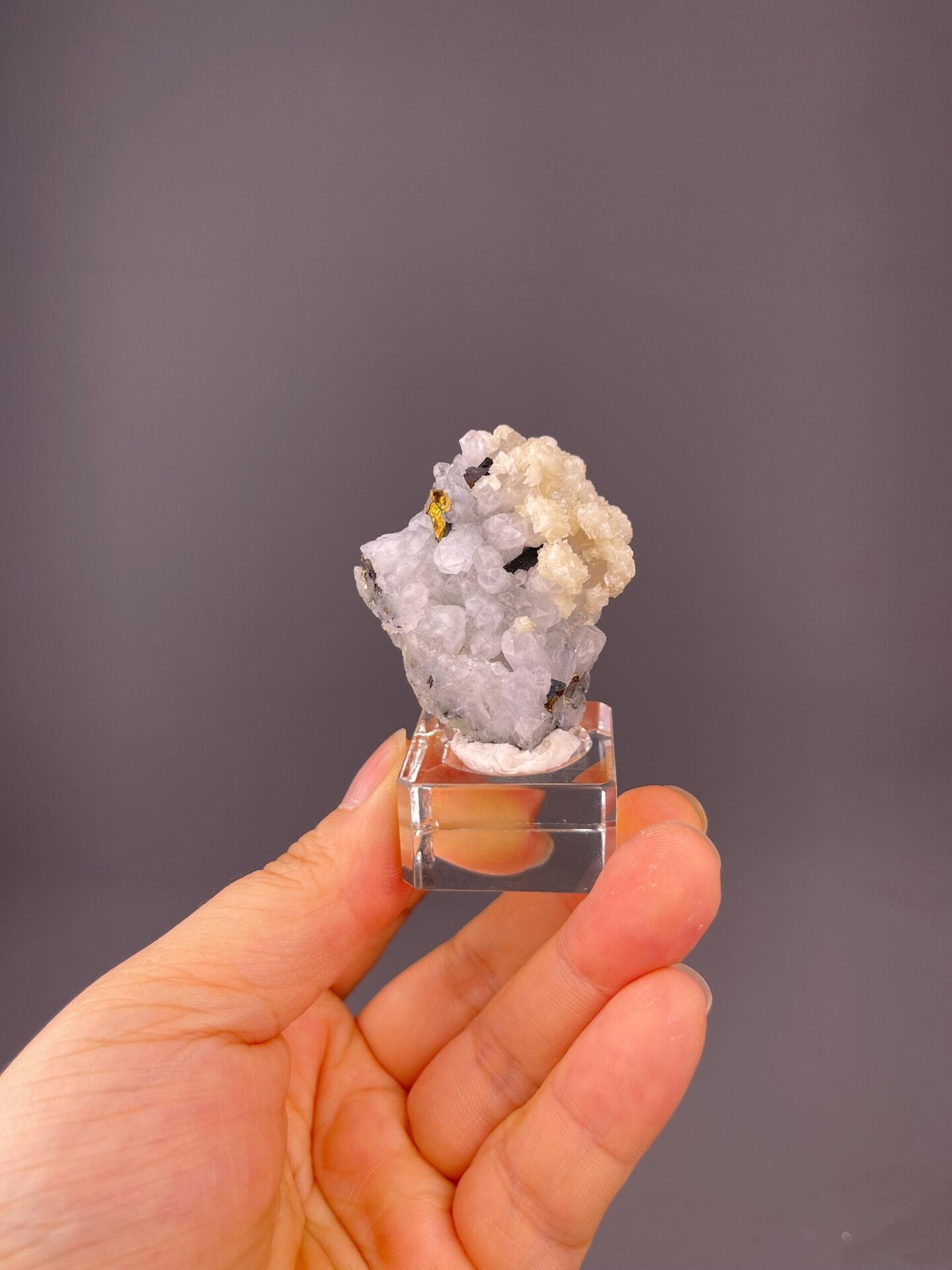 Front view of quartz cluster showing calcite and chalcopyrite accents