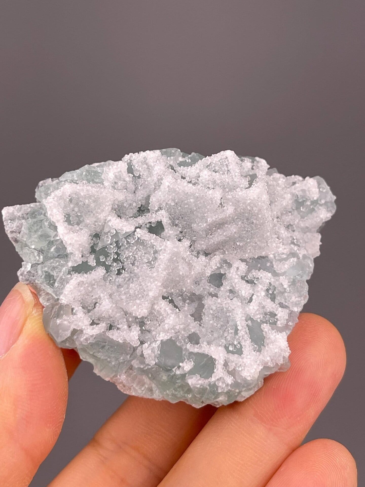 Side view of fluorite with druzy quartz overgrowth