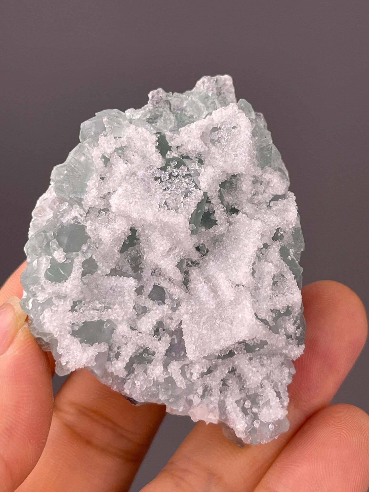Angled view of translucent green fluorite with druzy coating