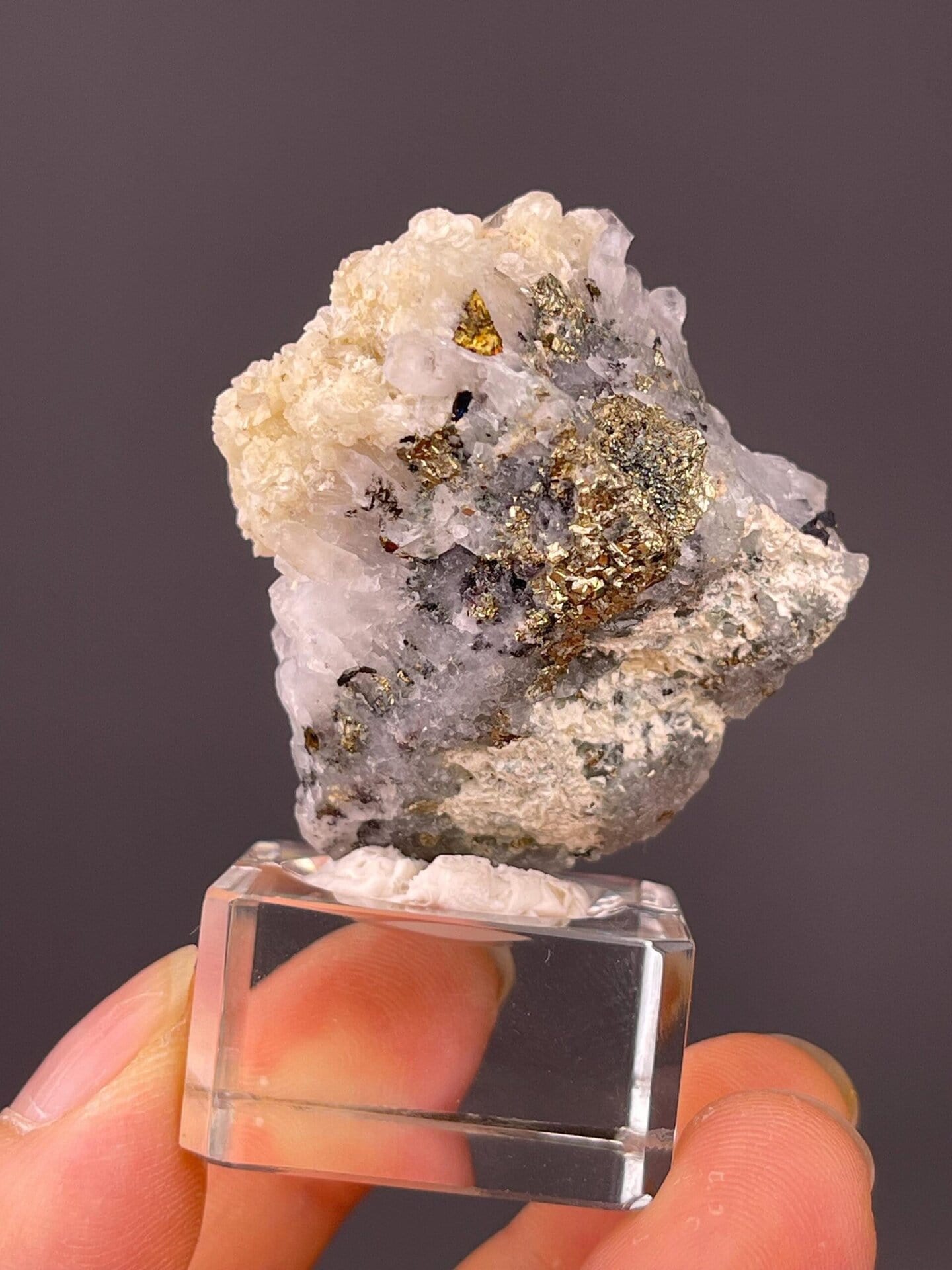 Detail of chalcopyrite iridescence on quartz-calcite cluster