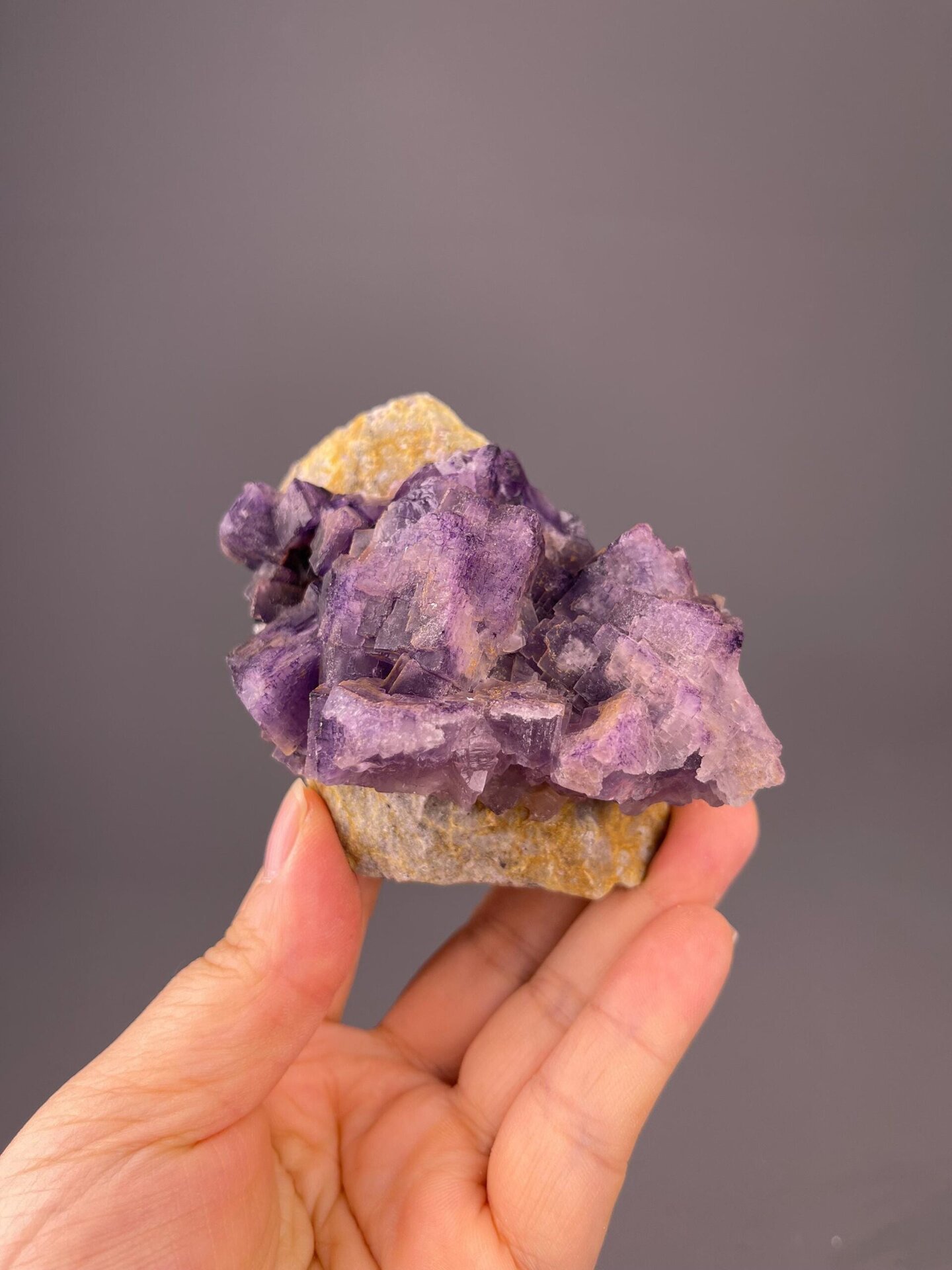 Front view of fluorite cluster showing etched crystal surfaces