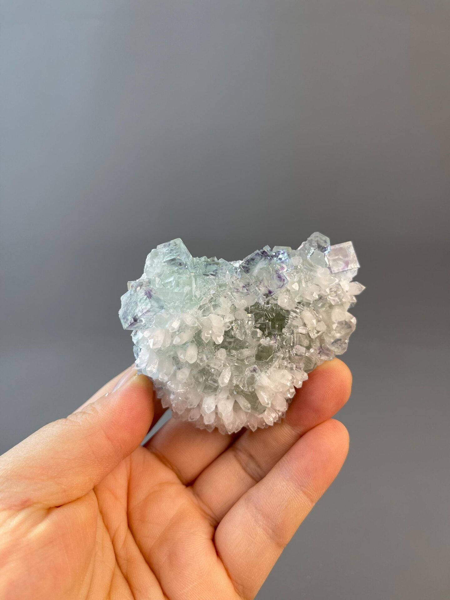 Side view of two-tone green purple fluorite cluster