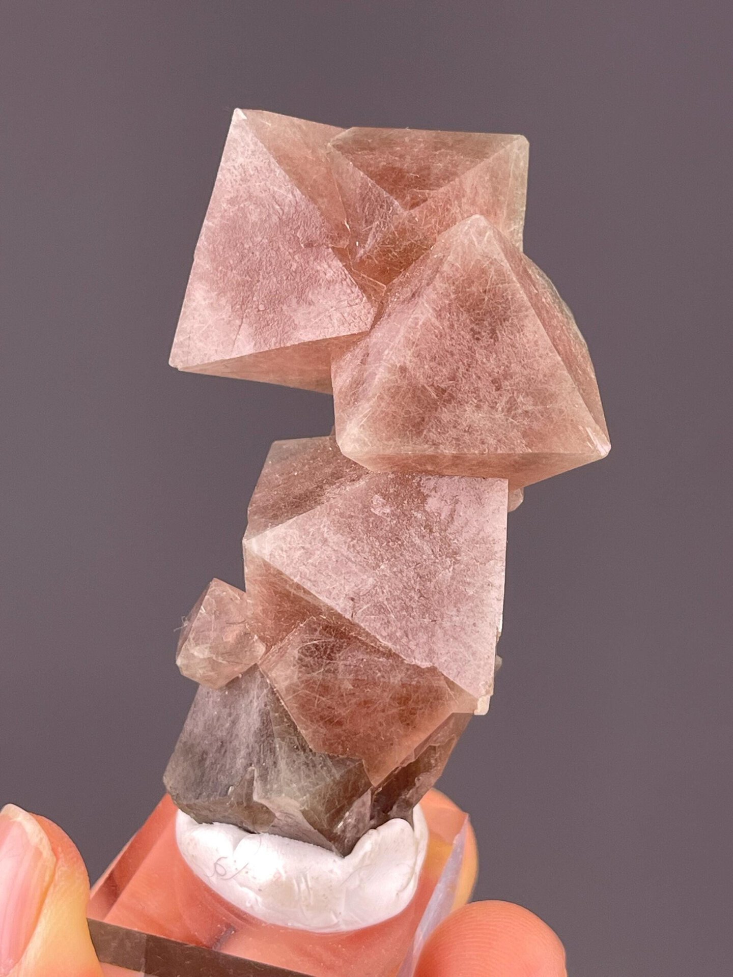 Red fluorite octahedral cluster displaying vitreous luster