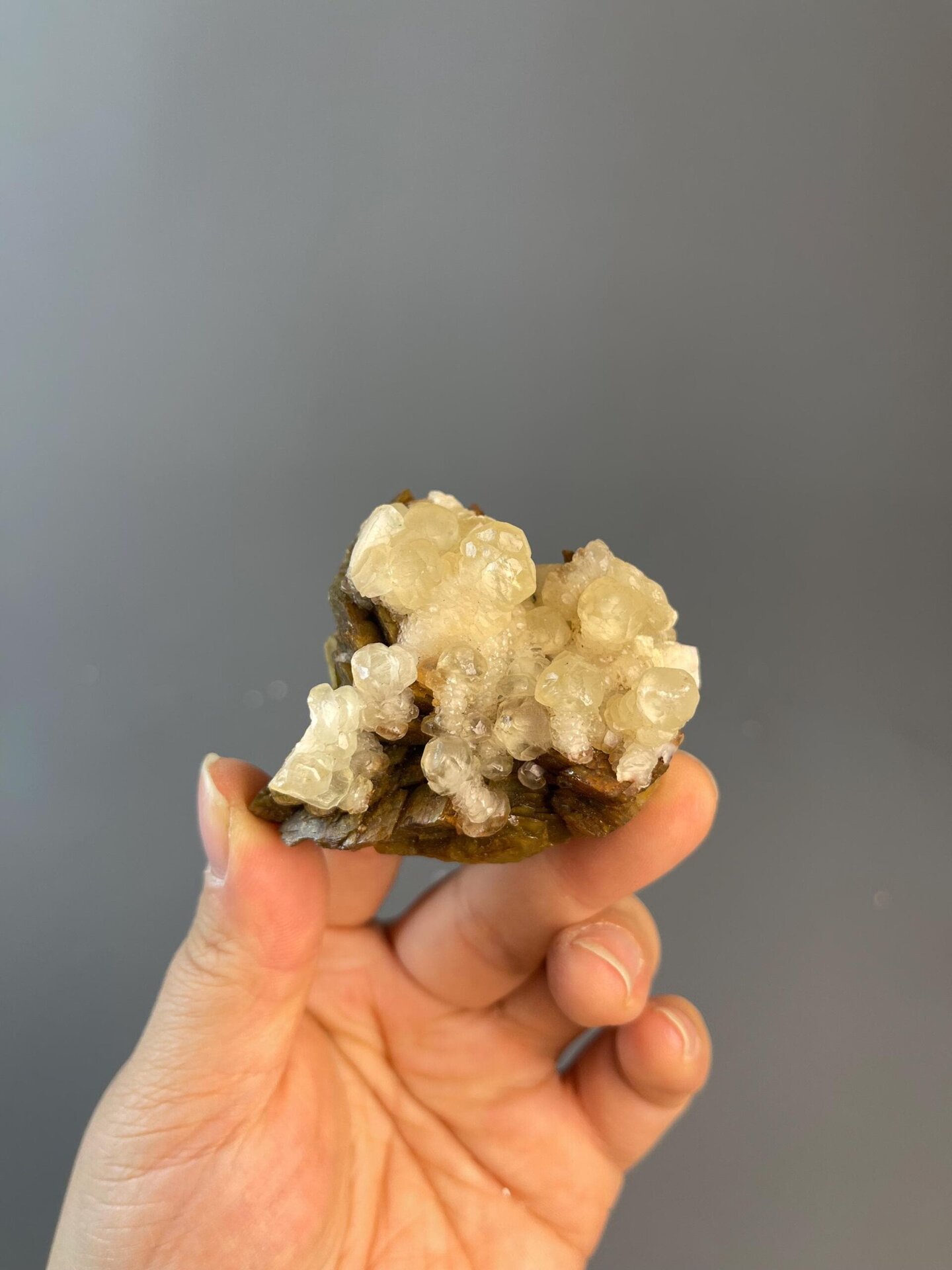 Semi-transparent calcite droplet on yellow matrix, Hunan