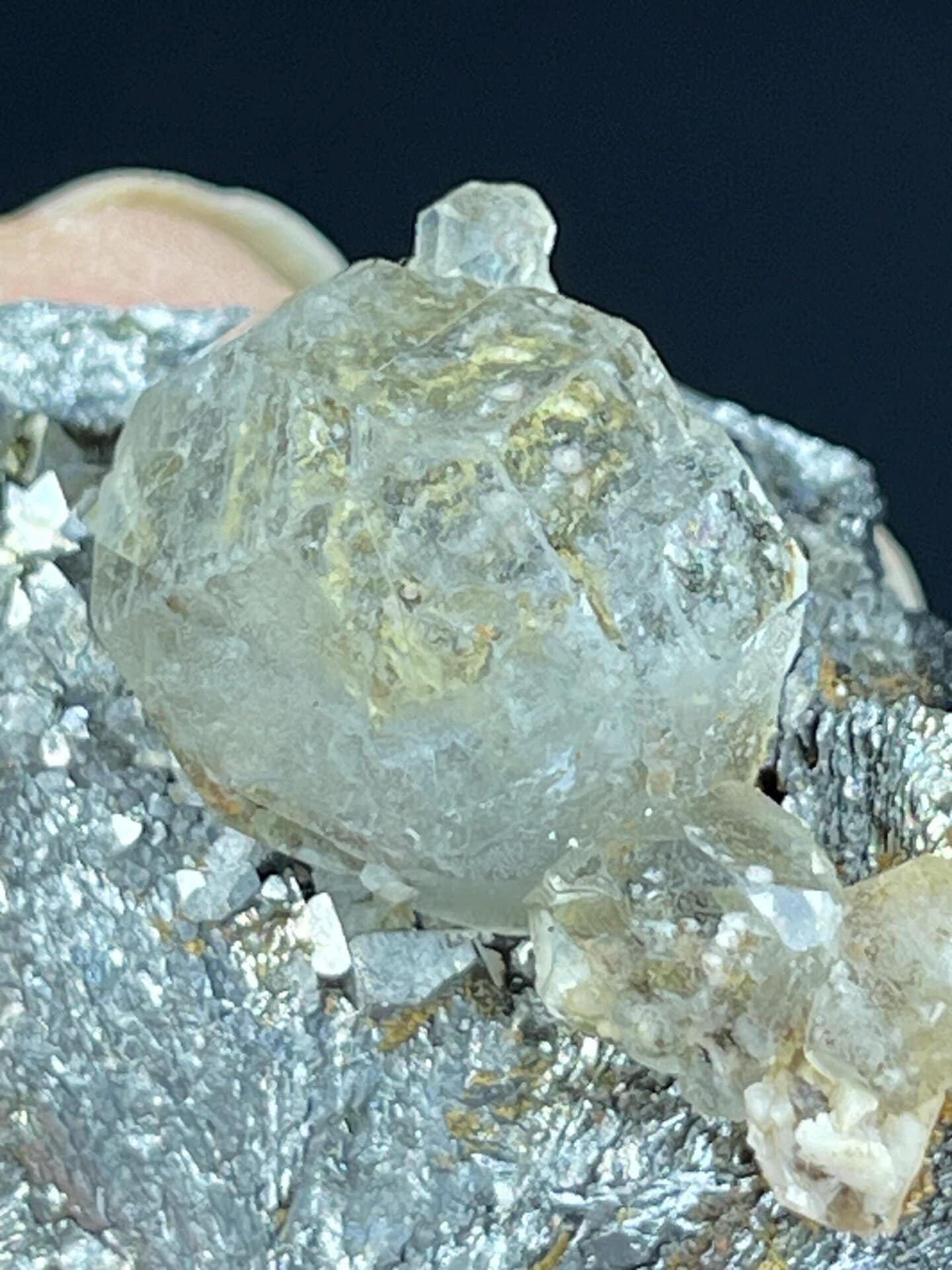 Scale view of 1.4x0.7x1.1 in fluorite sphere on iron