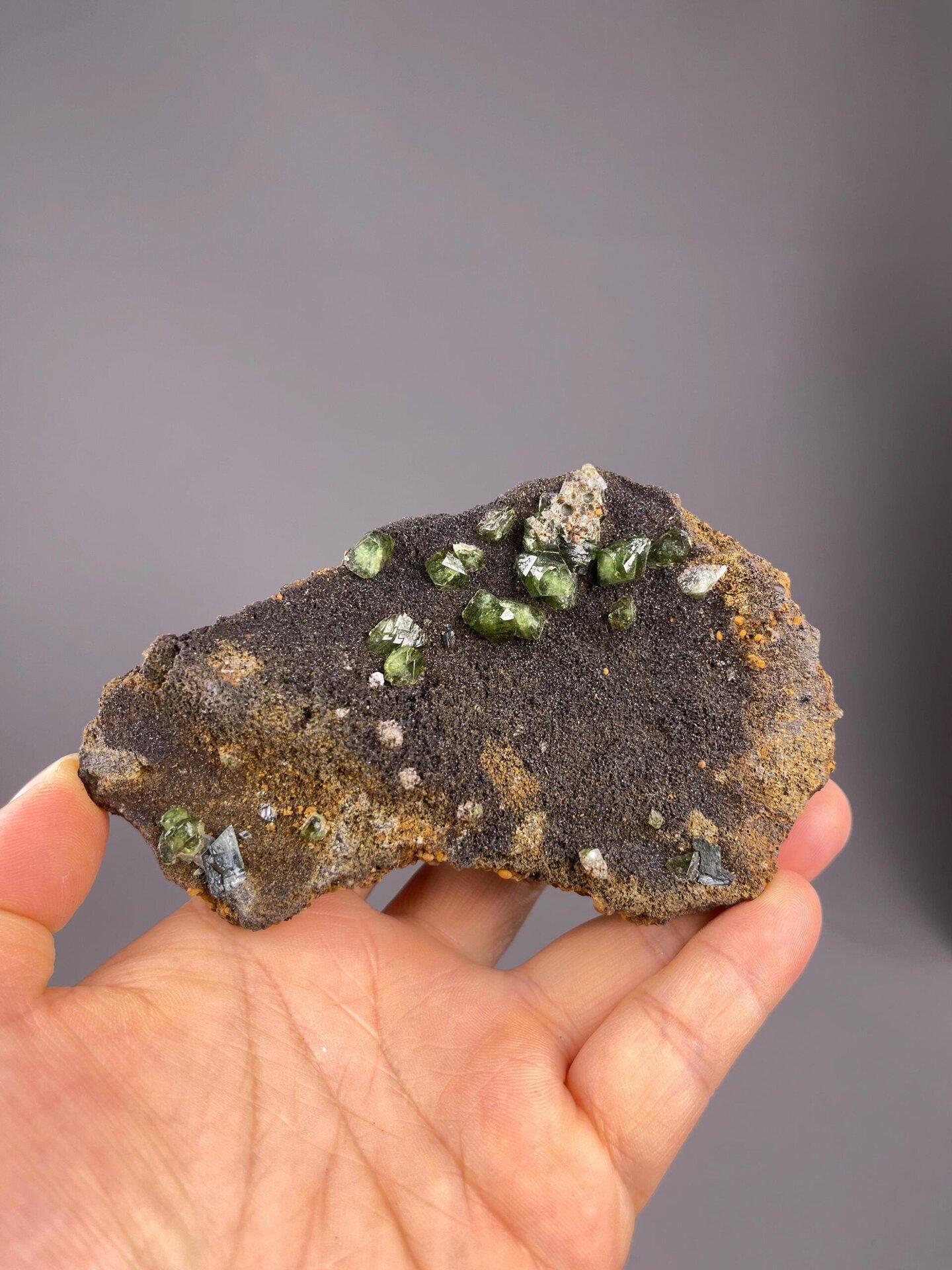Lustrous green andradite garnet crystals on dark matrix