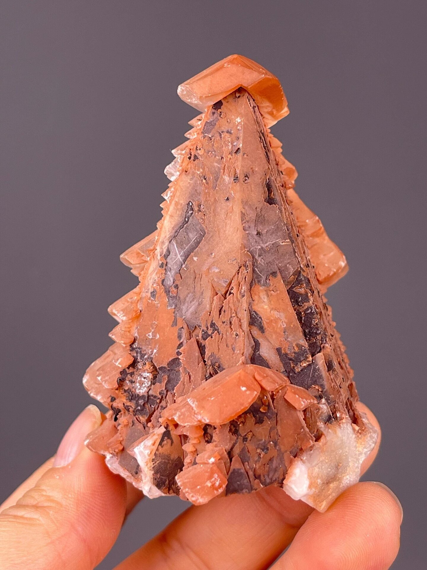 Close-up of calcite scalenohedral faces with red coloration