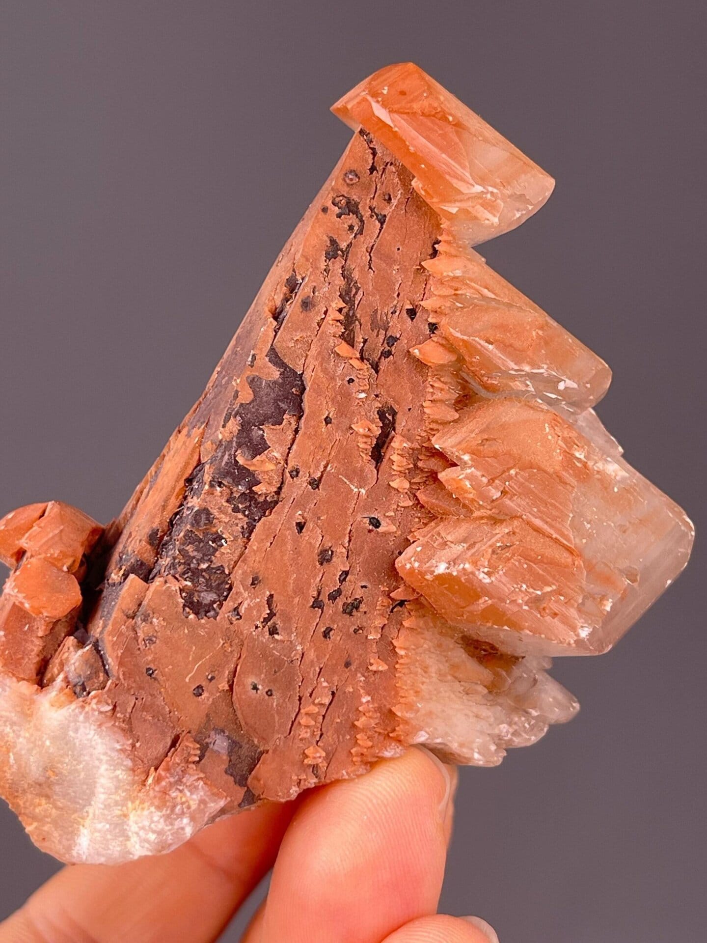 Natural scalenohedron calcite tower form in red-brown