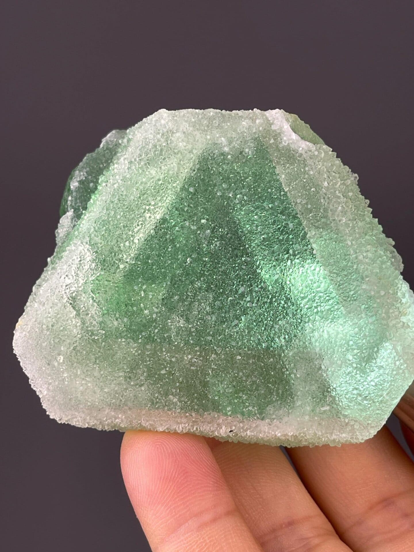 Mint-green fluorite alongside deep violet companion crystal