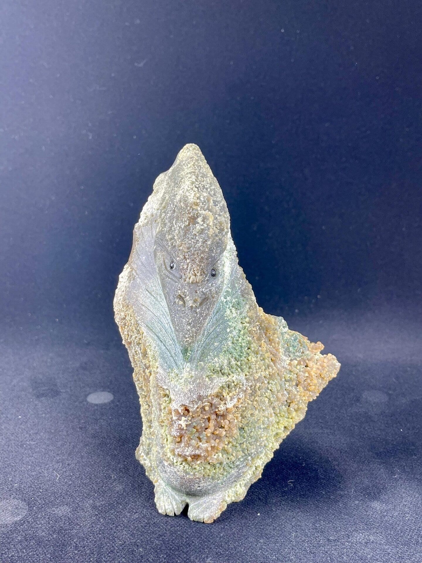 Side view of grape agate pterosaur sculpture, Indonesia