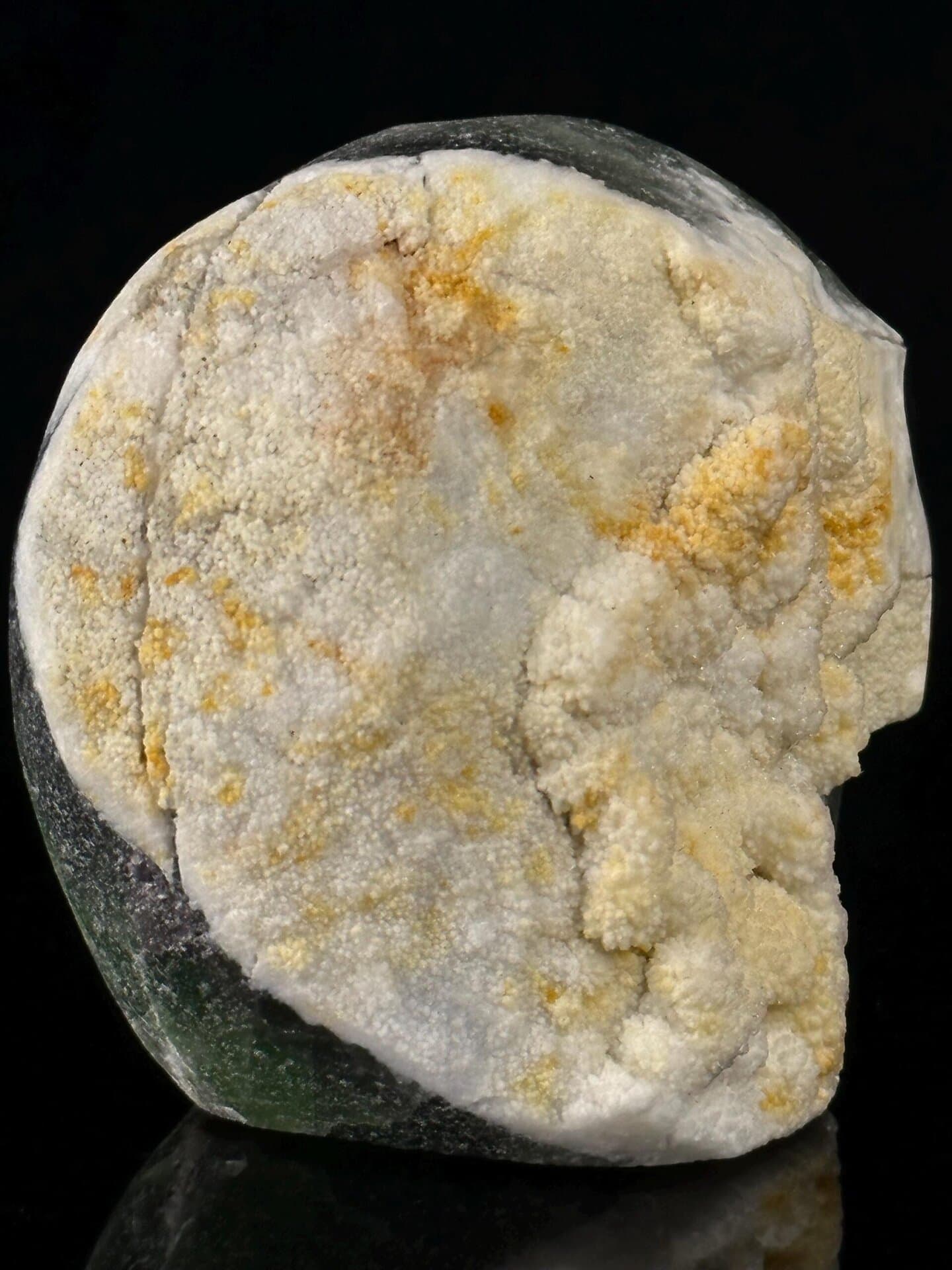 Fluorite carving with skull form and hollow crystalline interior