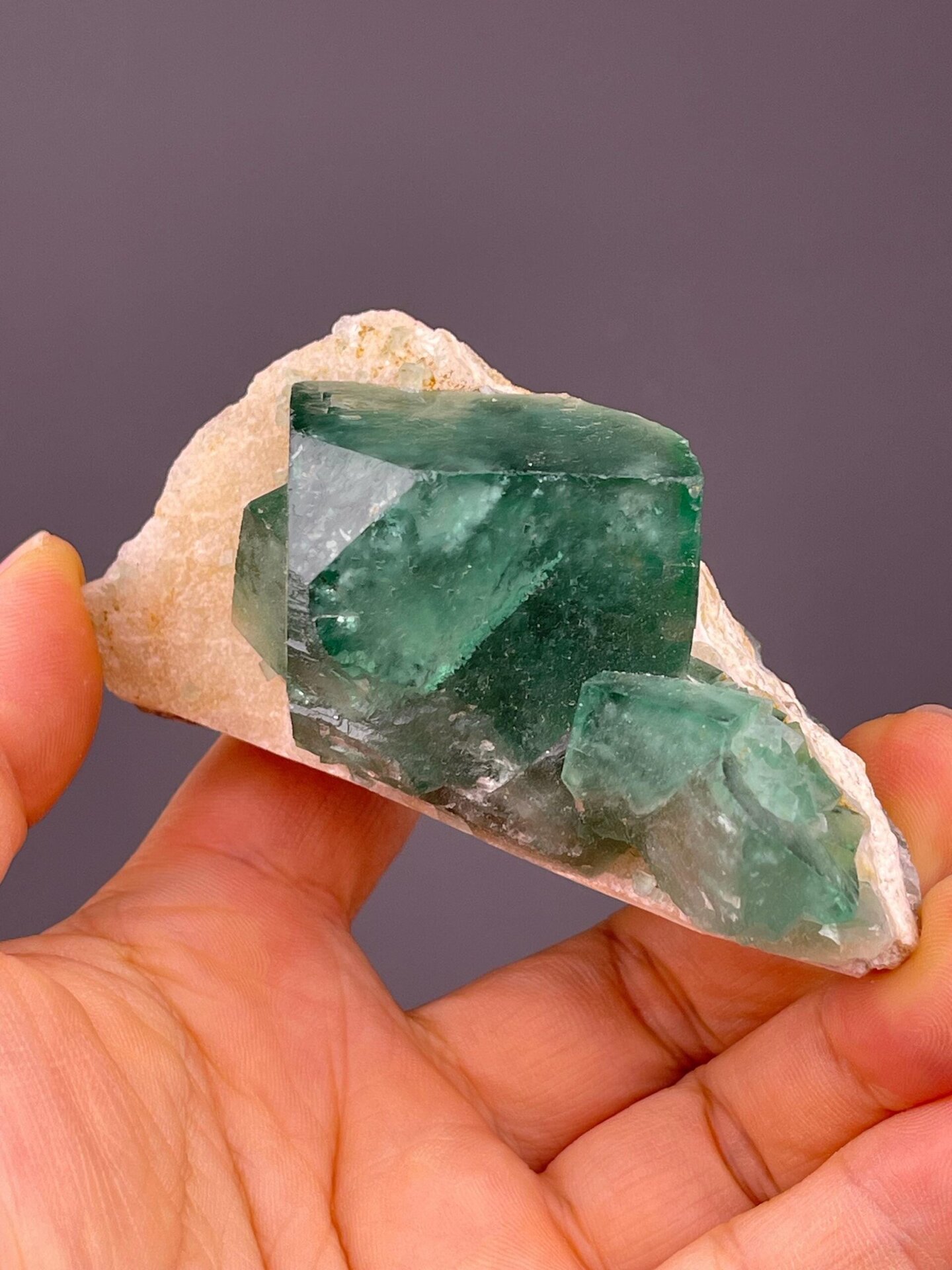 Daylight-reactive green fluorite cube from Madagascar
