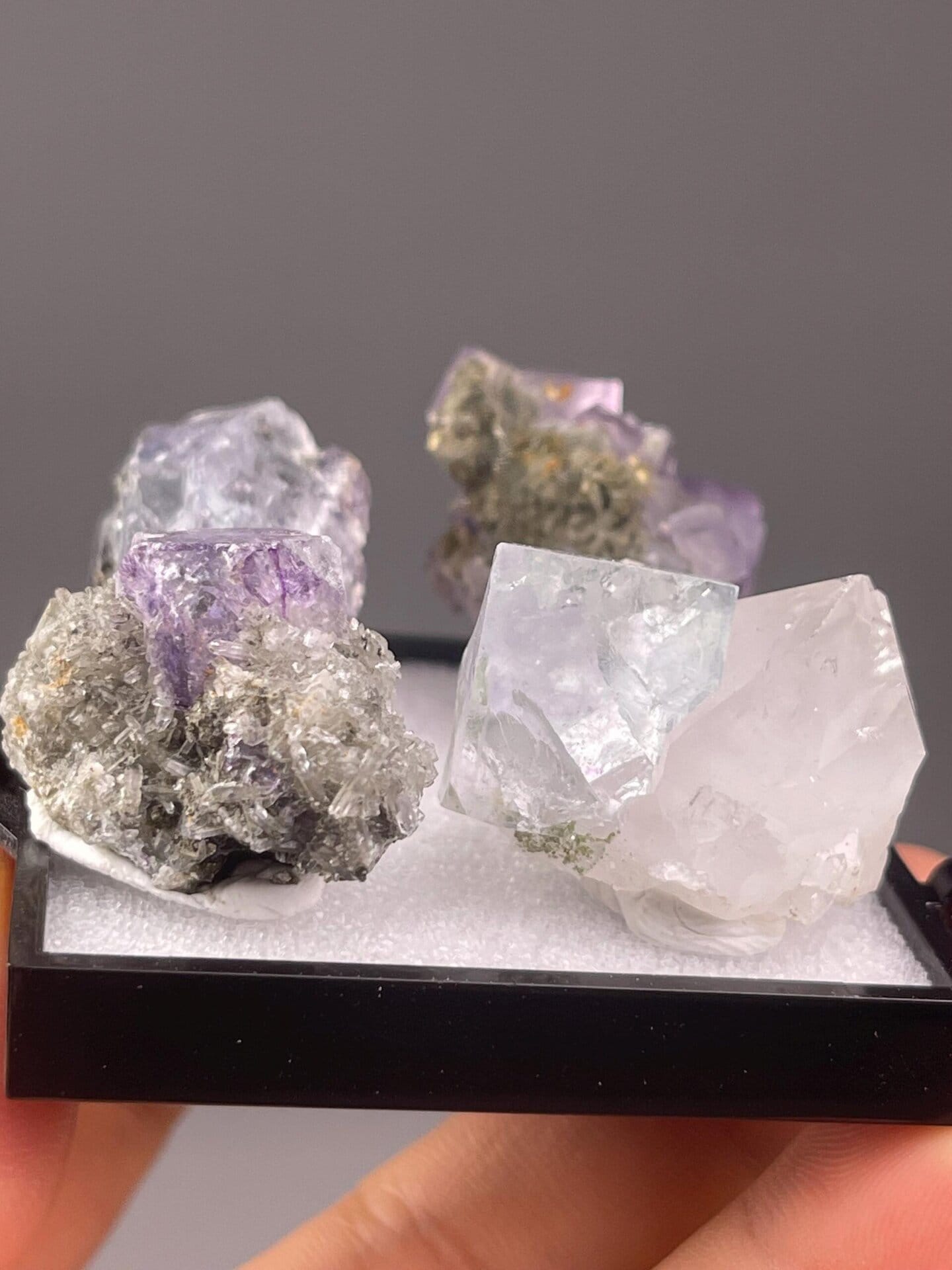Four matching purple fluorite cubes arranged together