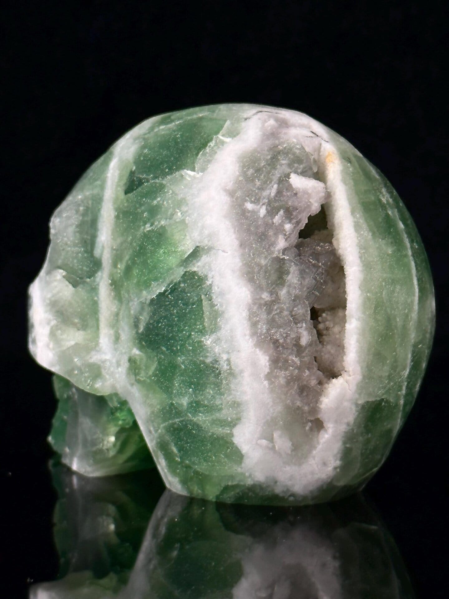 Green and white fluorite coloration on skull carving
