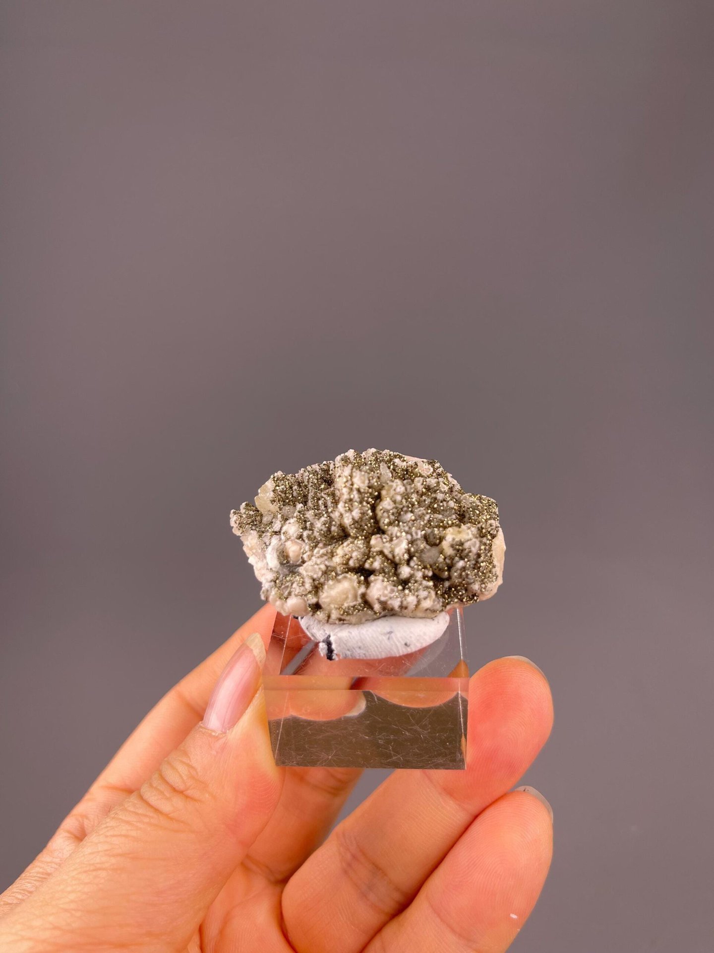 Golden pyrite cubes on white dolomite close-up