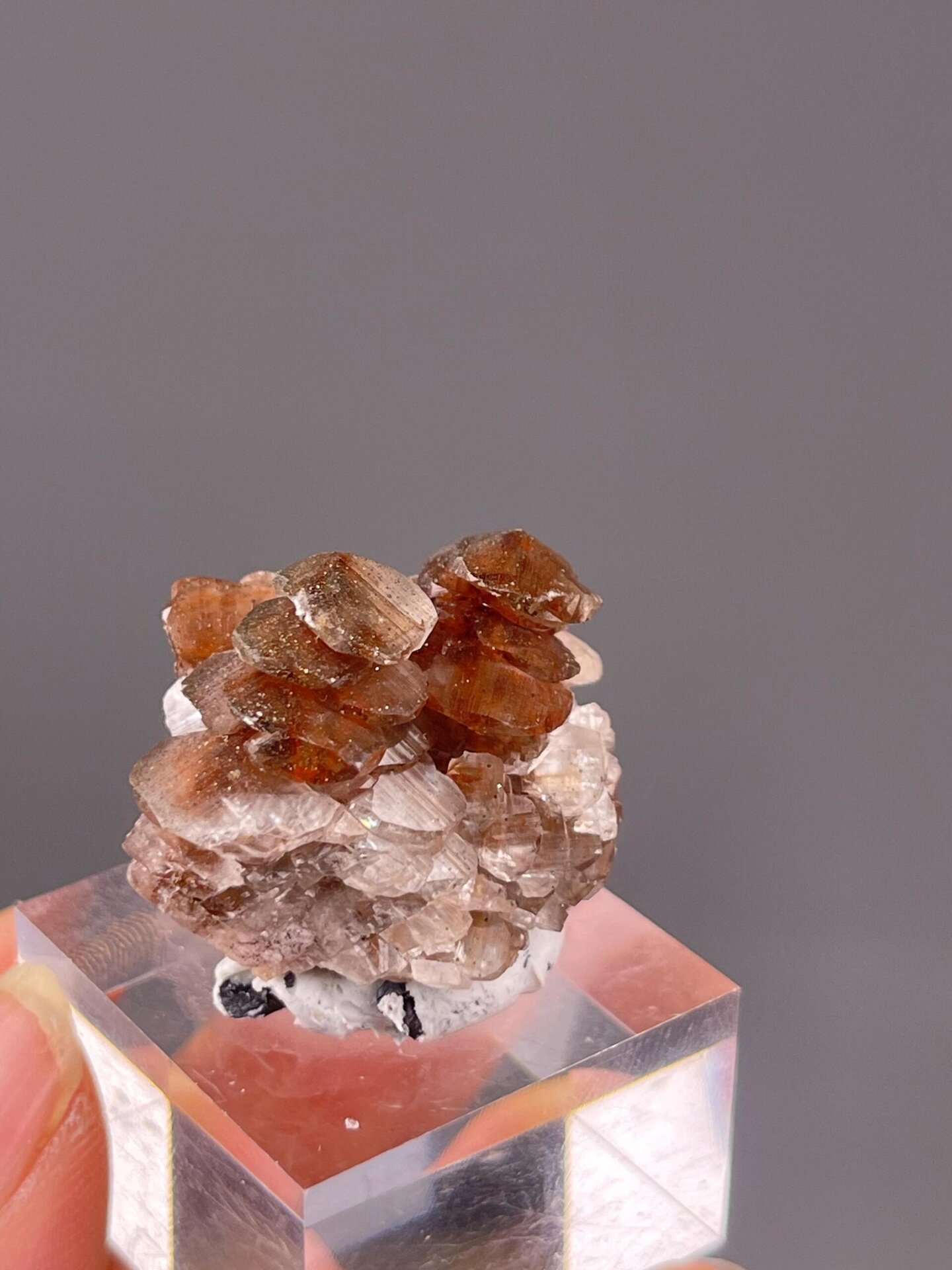 Full red calcite specimen on white background