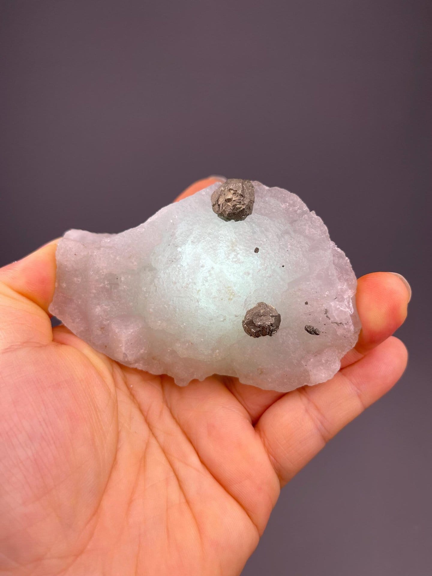 Front view of pale green fluorite with iron ore nodules