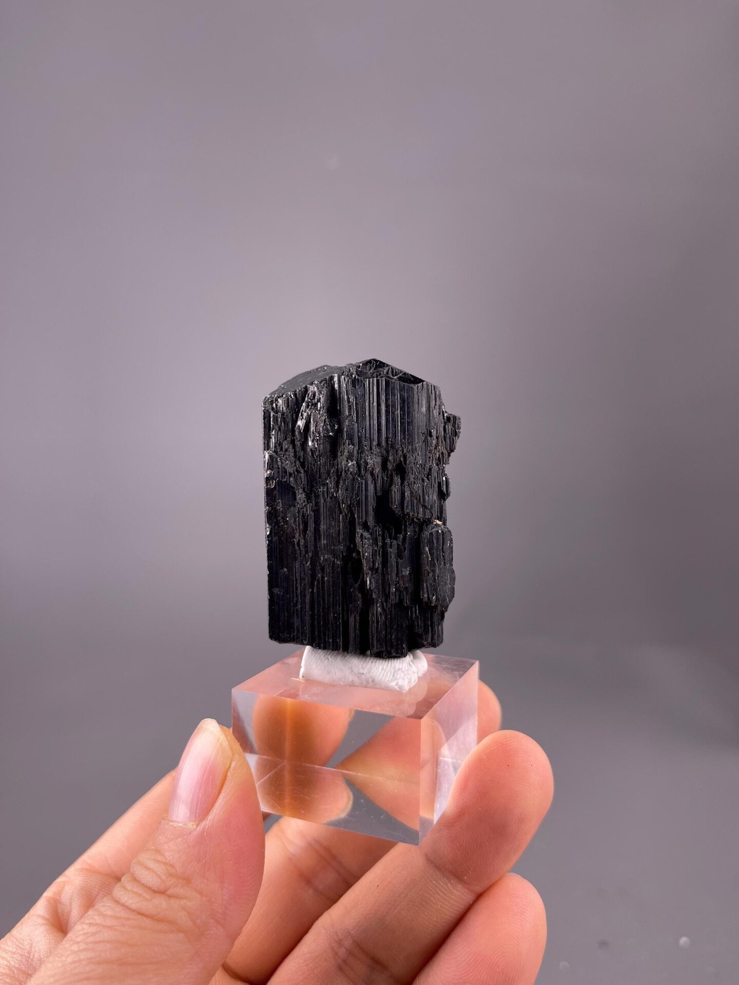 Vertical striations on black tourmaline crystal surface
