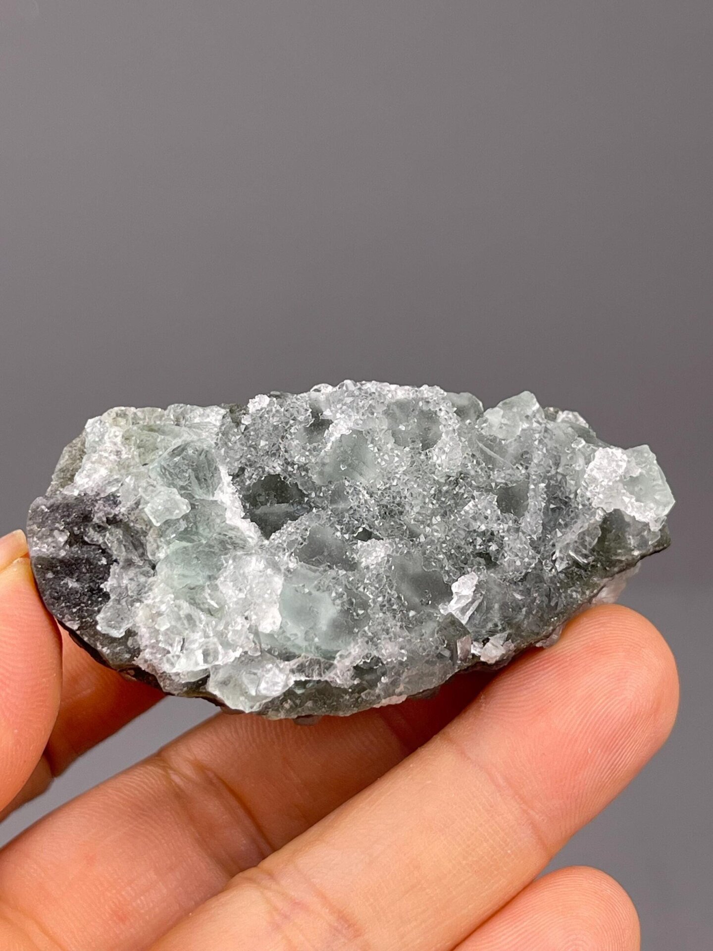 Raw sugar-coated fluorite under studio lighting
