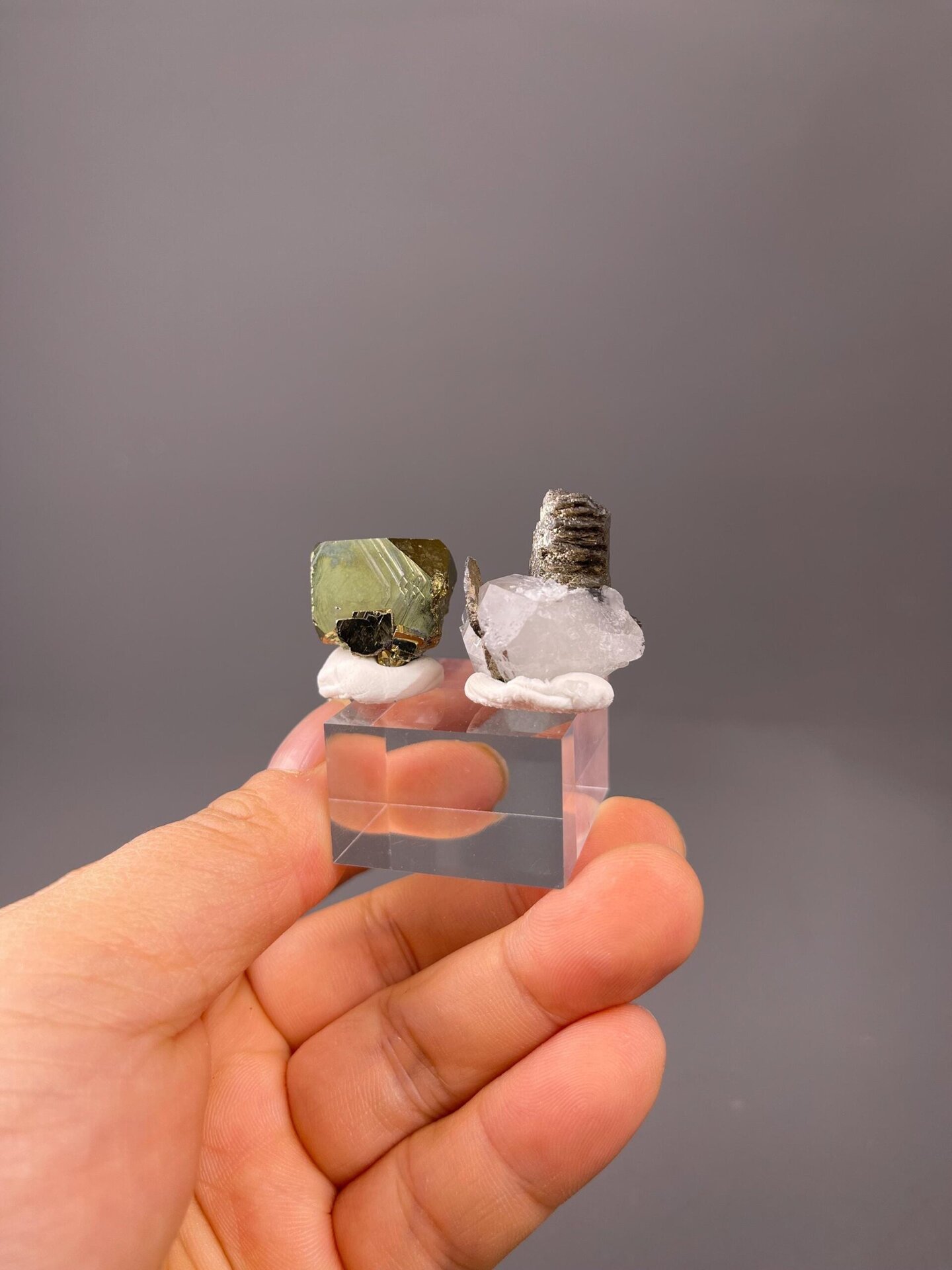 Raw iron ore specimen alongside chalcopyrite