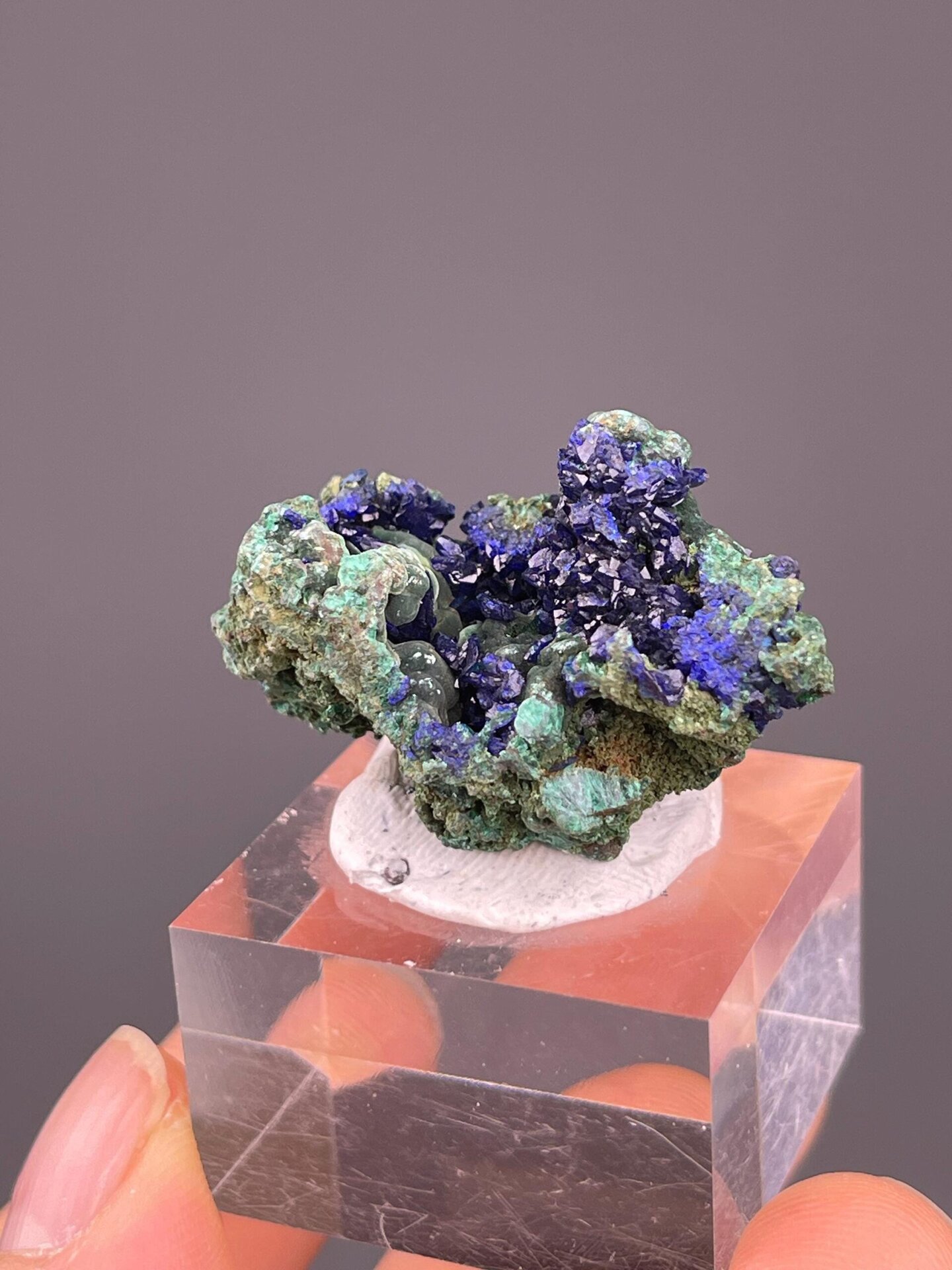 Green malachite matrix beneath blue azurite